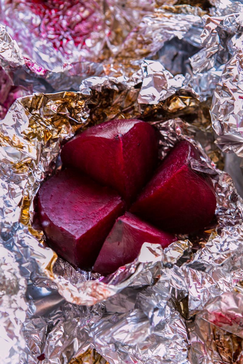 Roasted red Beets on Foil on grey surface