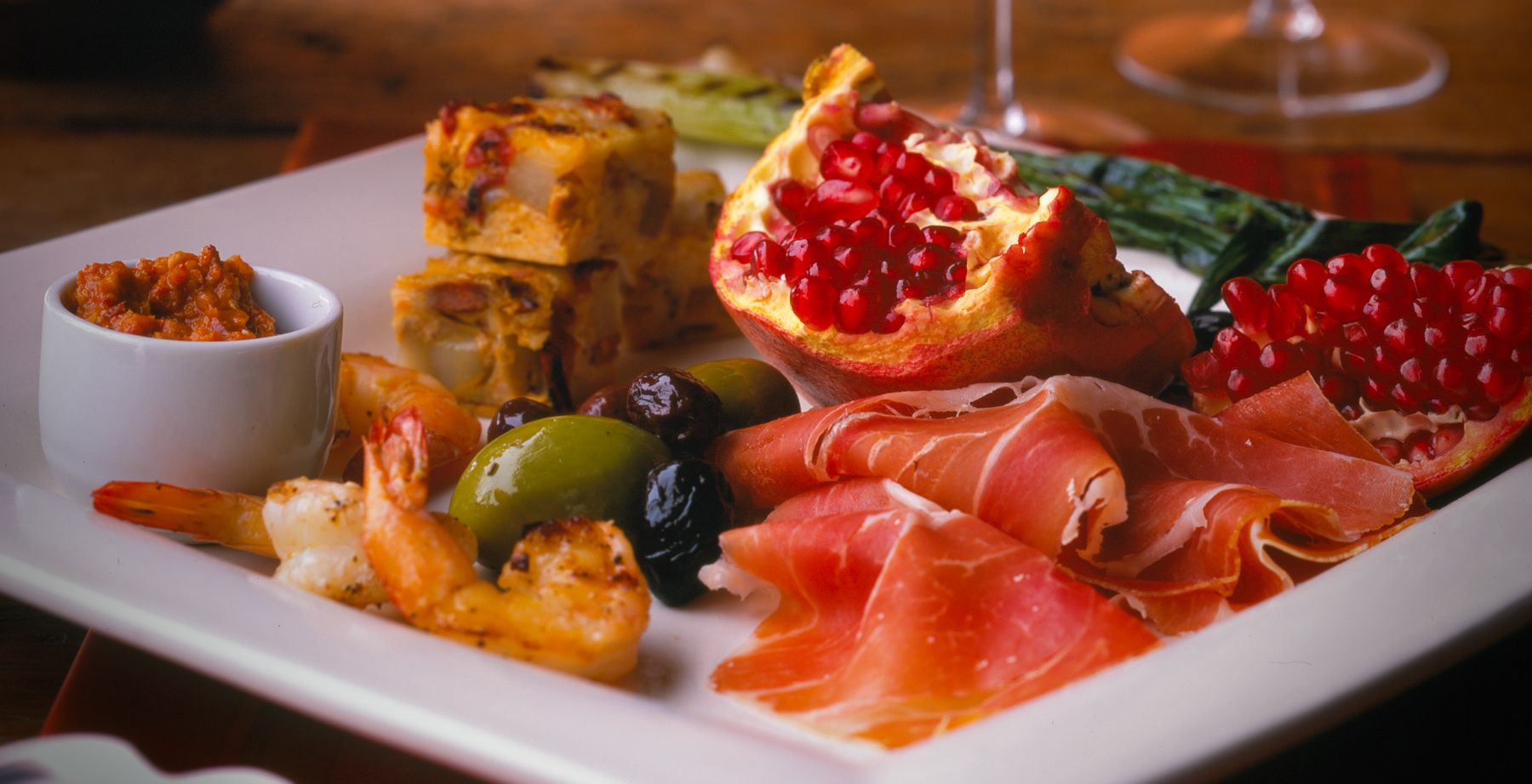 appetizing plate with, pomegranites, olives, shrimp, prosciutto  remolade  Robert Jacobs photography ©2013  www.rkjacobs.comtop food photographer New York Seattle Portland Robert Jacobs photography ©2013
