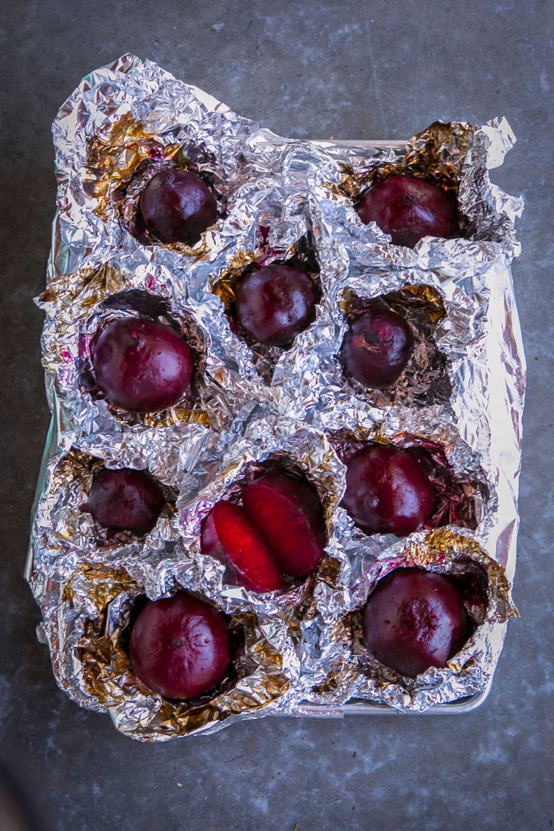 Roasted red Beets on Foil on grey surface