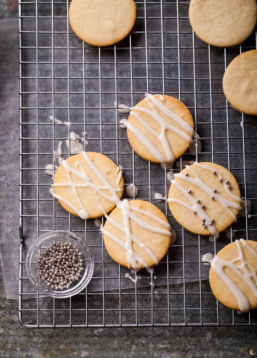 Sugar cookies with drizzled frosting on cooling rack with dragettsNew York Times Mark Bittman's app. "How to Cook Everything"www.rkjacobs.comTop Food Photographer New York Seattle PortlandRobert Jacobs Photography ©2013 Sugar cookies with drizzled frosting on cooling rack with dragettsNew York Times Mark Bittman's app. "How to Cook Everything"www.rkjacobs.comTop Food Photographer New York Seattle PortlandRobert Jacobs Photography ©2013
