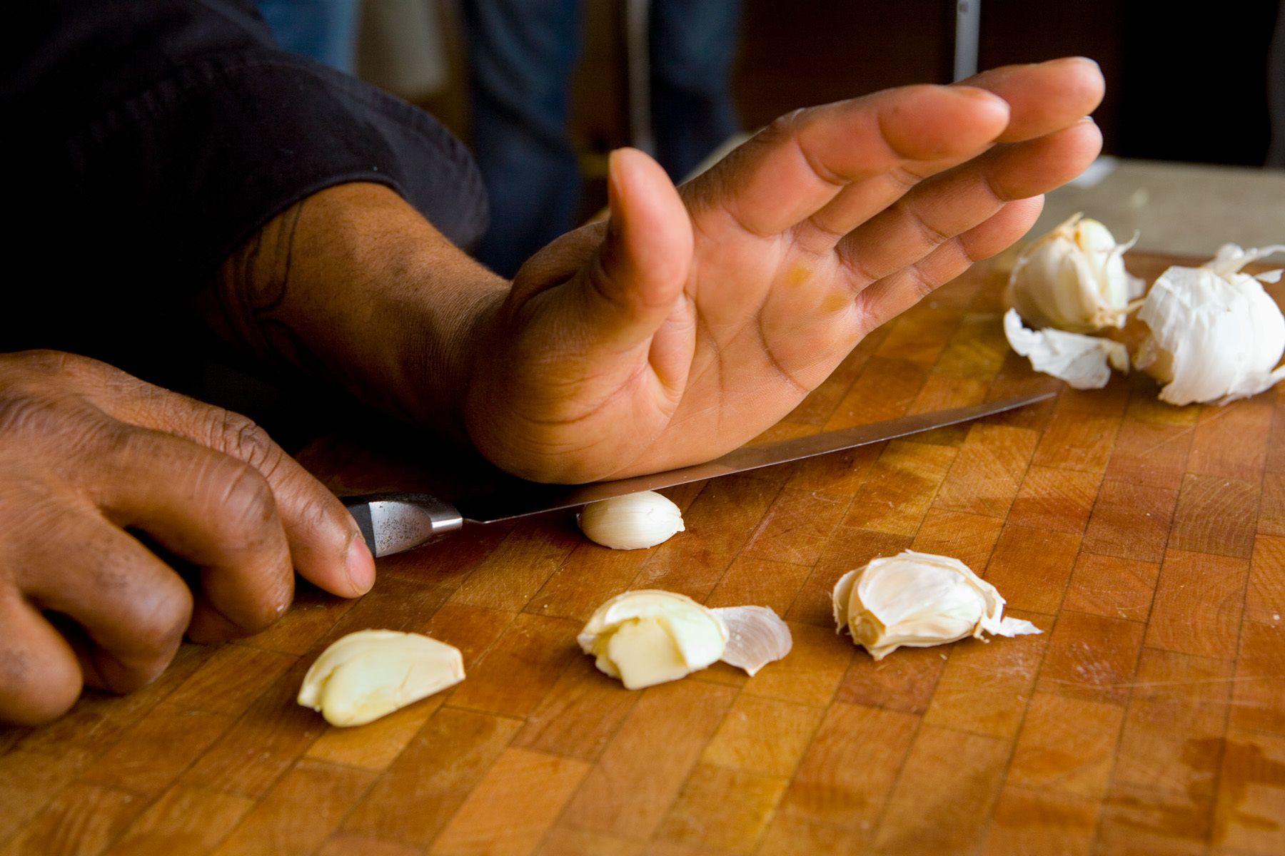 G.Garvin smashing garlic with hand and chef knife, www.rkjacobs.comTop Food Photographer New York Seattle PortlandRobert Jacobs Photography ©2013 G.Garvin smashing garlic with hand and chef knife, www.rkjacobs.comTop Food Photographer New York Seattle PortlandRobert Jacobs Photography ©2013