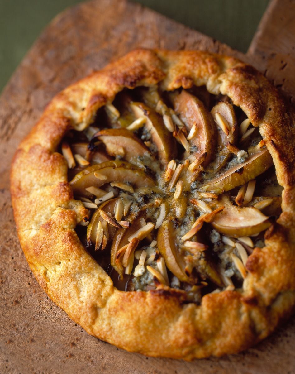 Galette with apples, almonds, stilton cheese on wooden cutting board www.rkjacobs.com