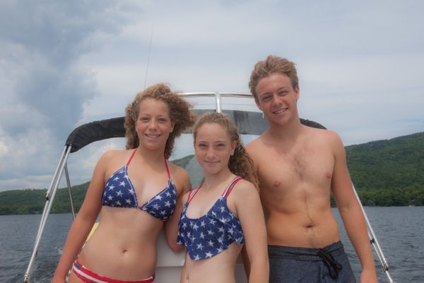teen age siblings smile on boat_7810.jpg