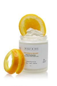 Jar of body butter with orange peel and orange slices