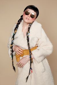 photo of Asian model with long braids and faux fur coat