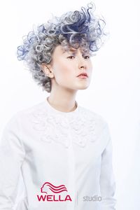 Photo of model with short blue curly hair 