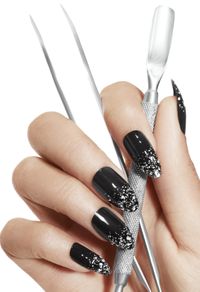 Fashion Nails holding manicure tools. Glitter Nail art  and luxury manicures.