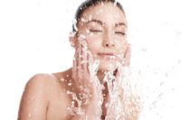 Photo of model splashing water on face