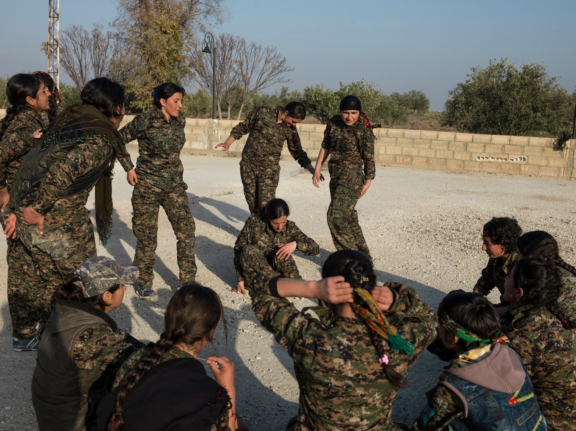 YPJ members playing volleyball and other games at the Martyr Payman Base in Serikani. They came here a few days ago to rest and train for a short while before going back to the frontline. 12.jpg