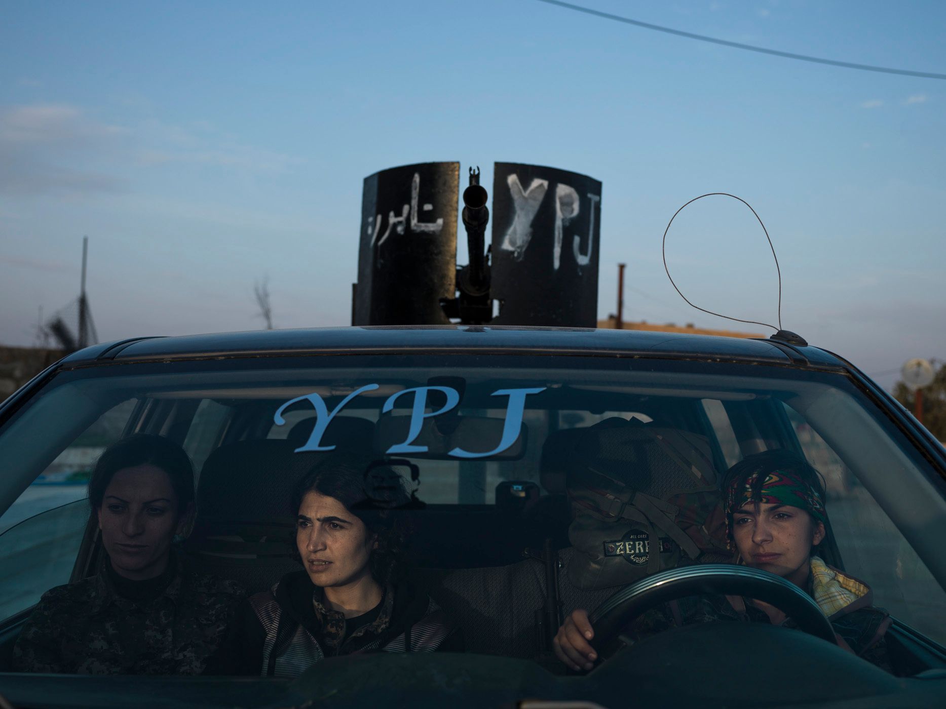 YPJ members sitting in an armed vehicle in Serikani. 22.jpg