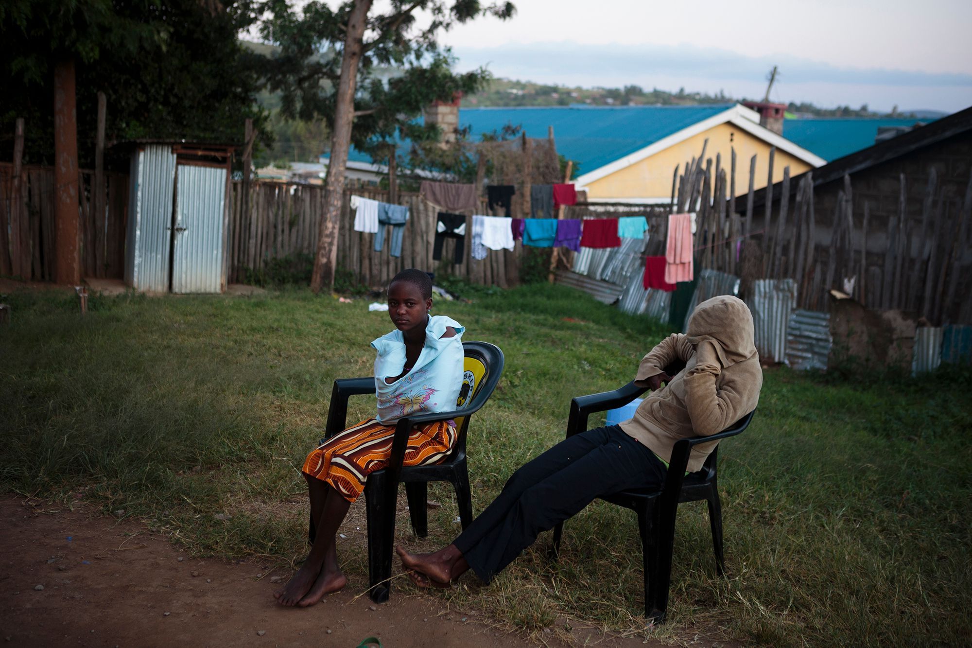 Anita and her friend Jane sitting in the front yard of the safe house. When asked why they looked so sad, they said that their dark memories keep coming back to them. 15.jpg