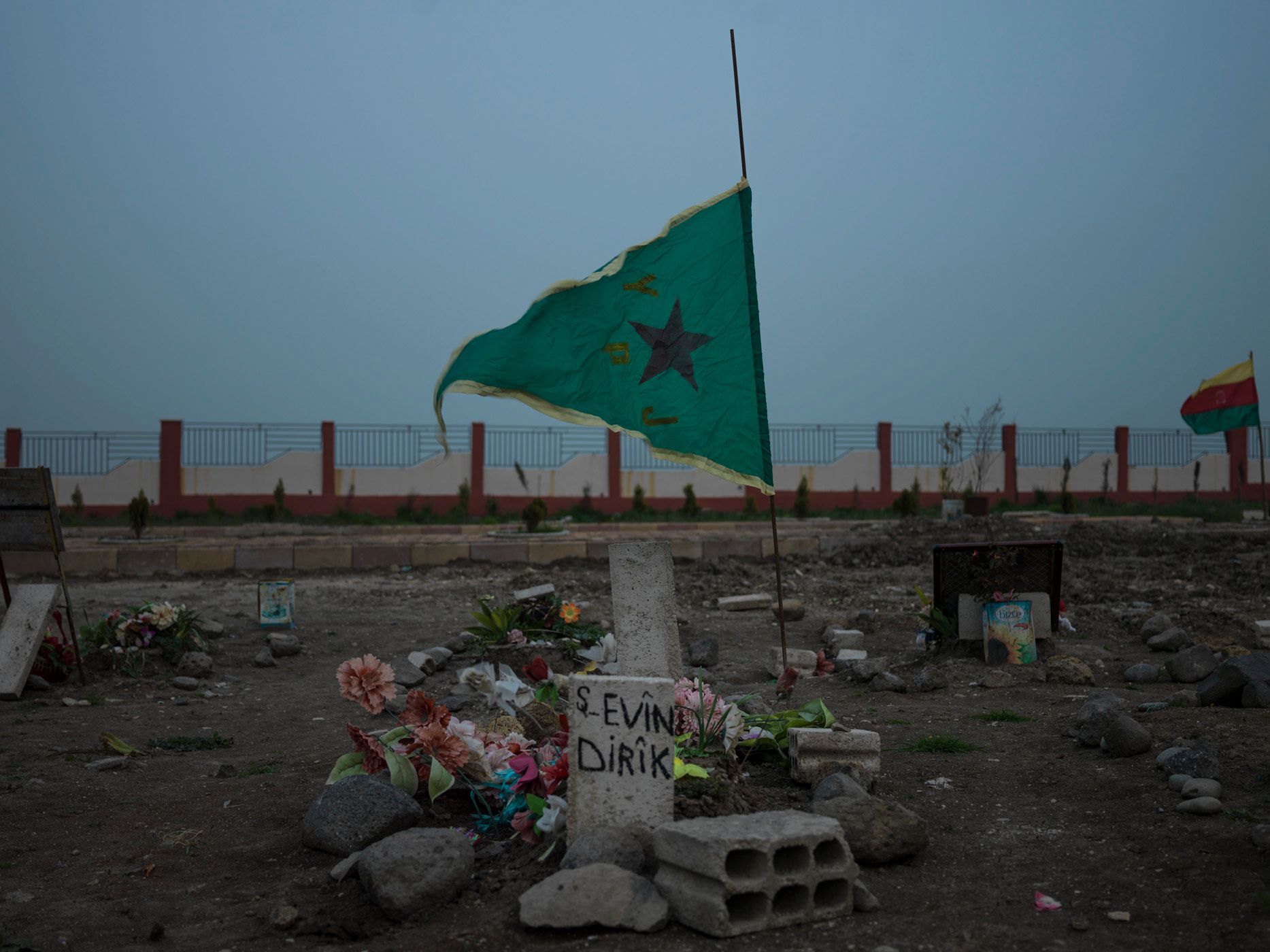 YPJ flag over the grave of a young female YPJ fighter killed by ISIS forces. Cemetery for YPJ and YPG members who were killed by ISIS; an hour from Derek. 09.jpg