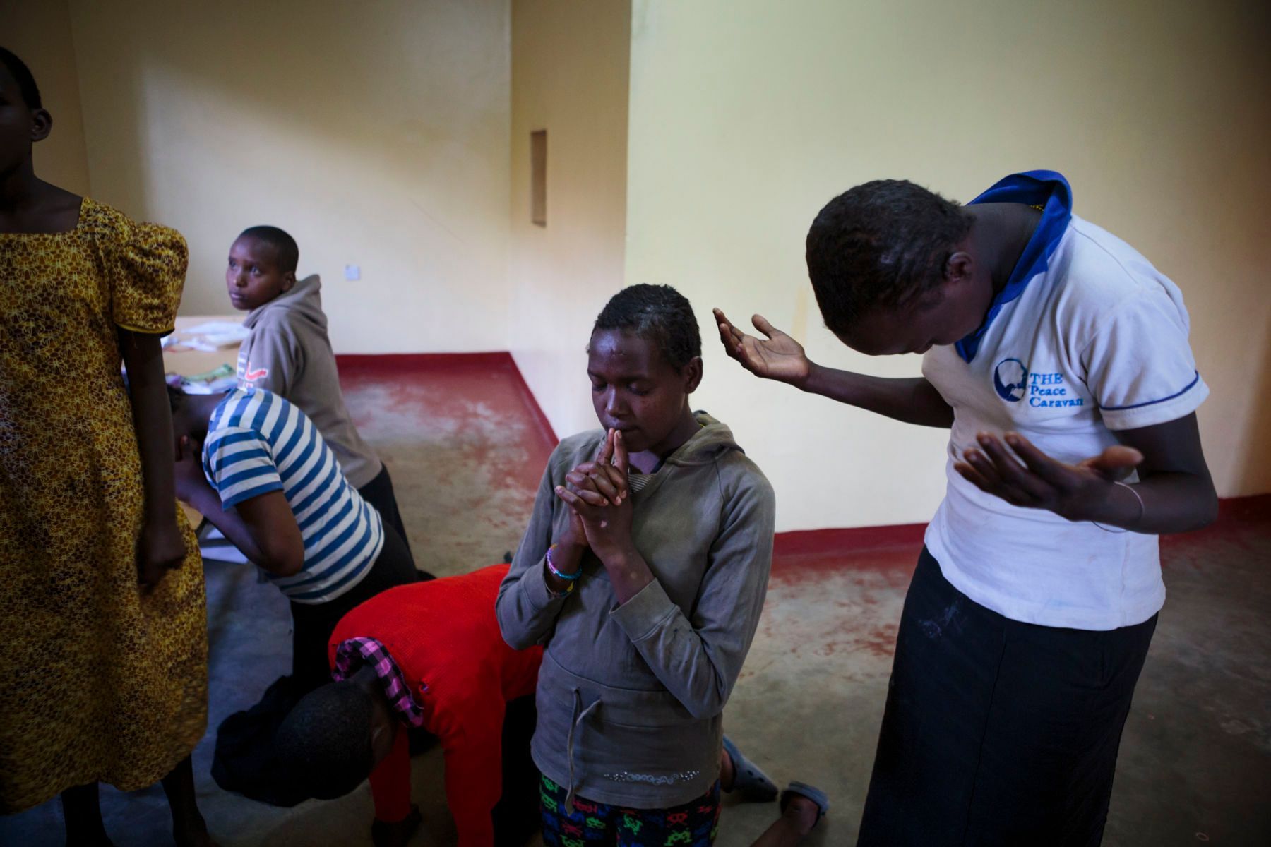 Young FGM and forced marriage survivors pray together at the safe house. Prayer is one of the few things that bring the girls comfort. 10.jpg