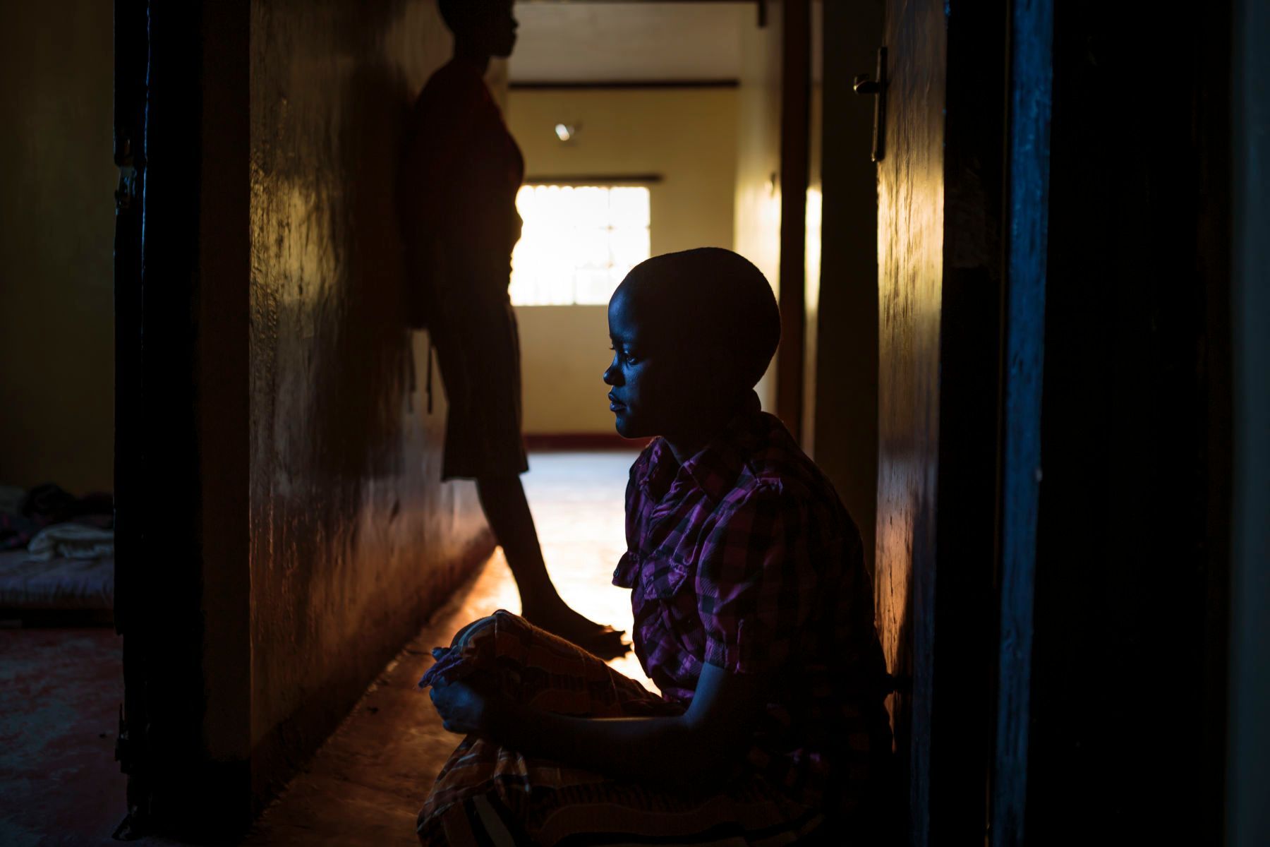 Anita, 13, sits in the corridor of the safe house. As a young girl, she worked as a milk seller and never went to school. When she found out her father had plans to marry her off to an old man, Anita reached out to an aunt for help. Her aunt brought her to the Samburu Girls Foundation where she now resides. 07.jpg