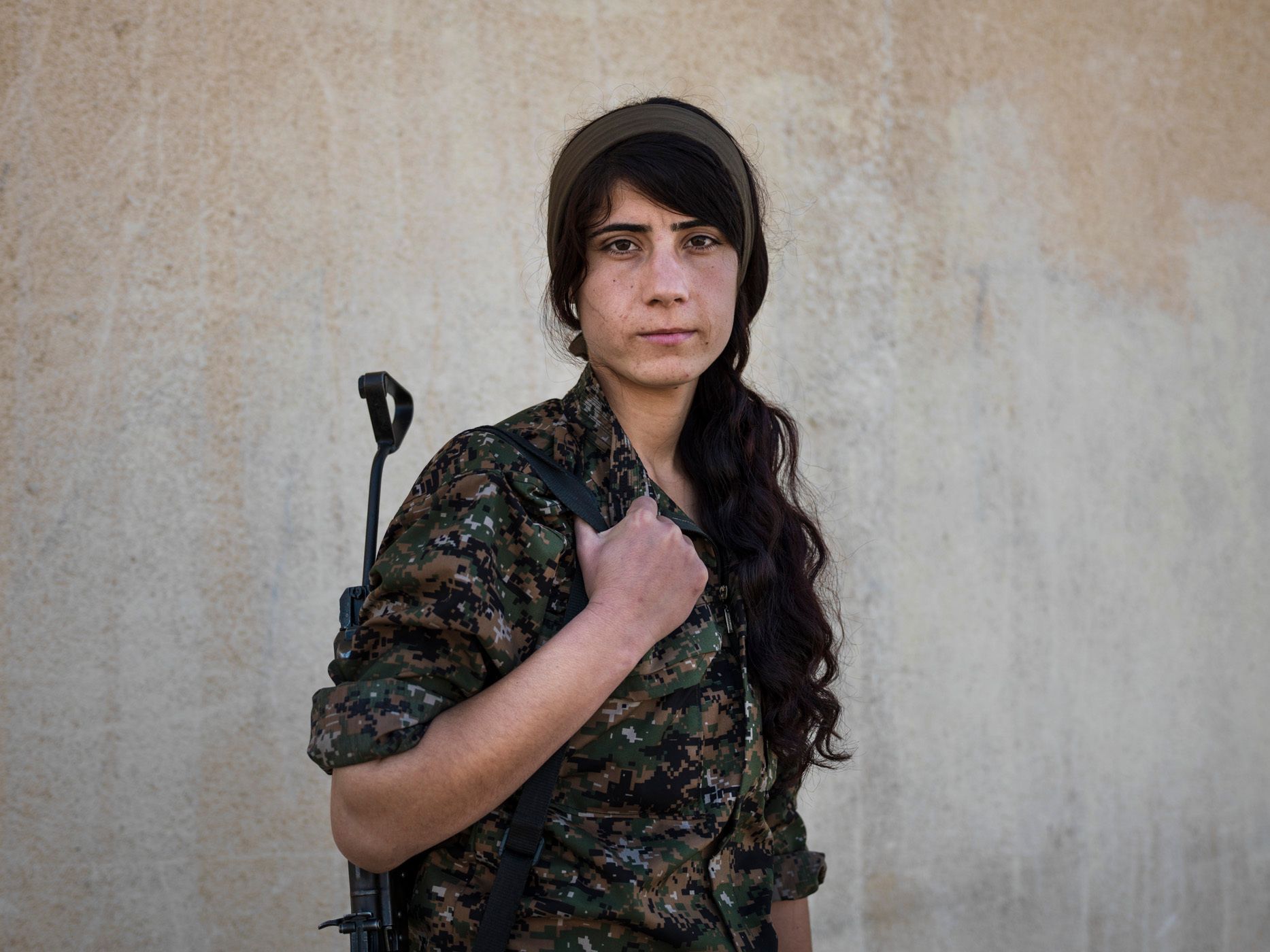 Suzdar, 21, from Qamishlou, joined YPJ four years ago. "When the revolution happened in Rojava, I knew that I wanted to have a role in it. The majority of the members of our society are women, but the only roles they are allowed to play are those of home-makers and mothers. But in this revolution, the YPJ women make up a whole army. And this is an opportunity for us women to show that we can play a different role. Usually men say that we cannot fight to defend ourselves and others, but with this revolution we are proving them wrong. My comrades and I attacked ISIS checkpoints in Talala. They were fighting back using all the heavy artillary they had. But we won the fight and seized the checkpoint and took the village under our own control. Now I feel that I can do anything I want. But before this, I thought that only my father and brother could protect me. But now as a YPJ woman, not only I can defend myself, but also I can protect others." 07.jpg