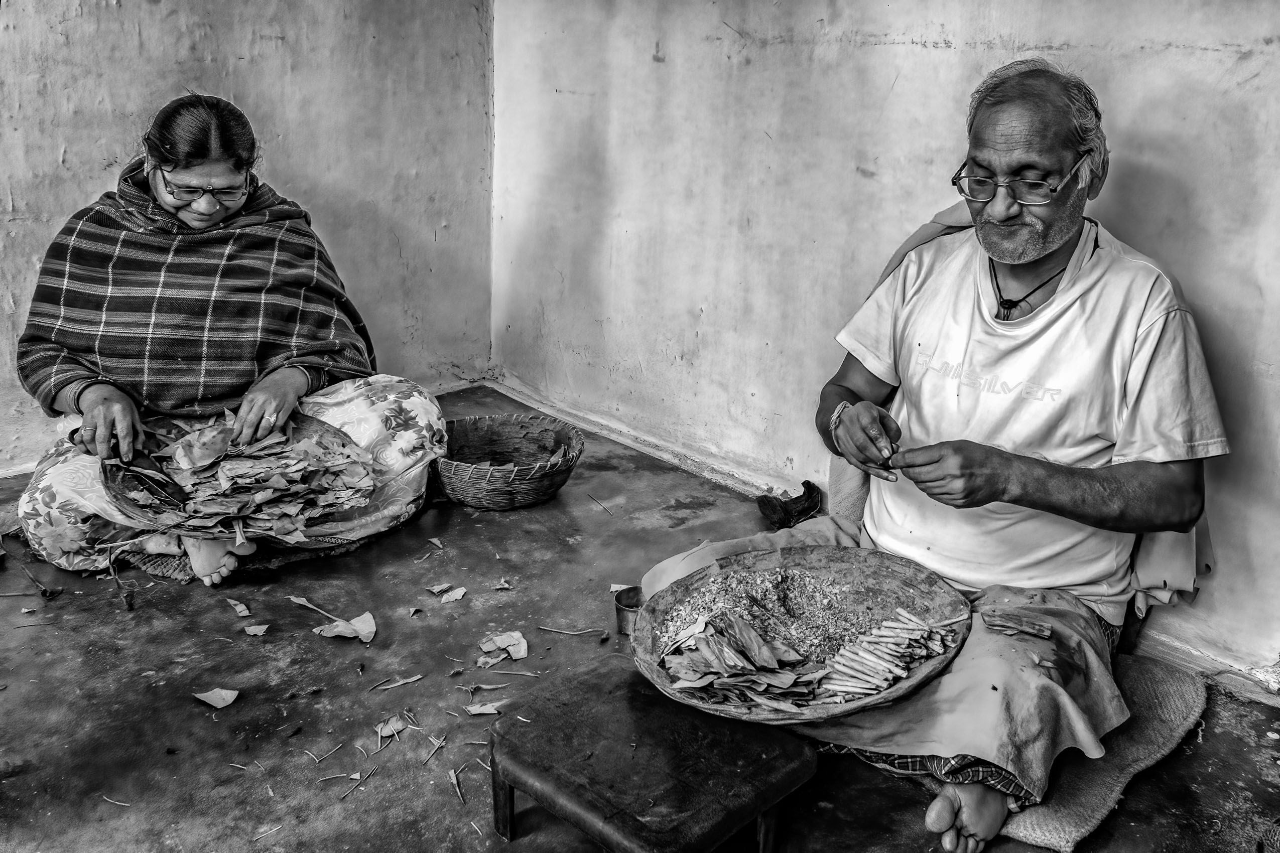 Beedi cigarette making as a cottage industry: The wife cuts up the leaves in which the husband wraps the tobacco, securing  each stick with a thin thread (Village in Chhattisgarh) work.laborers-29.jpg