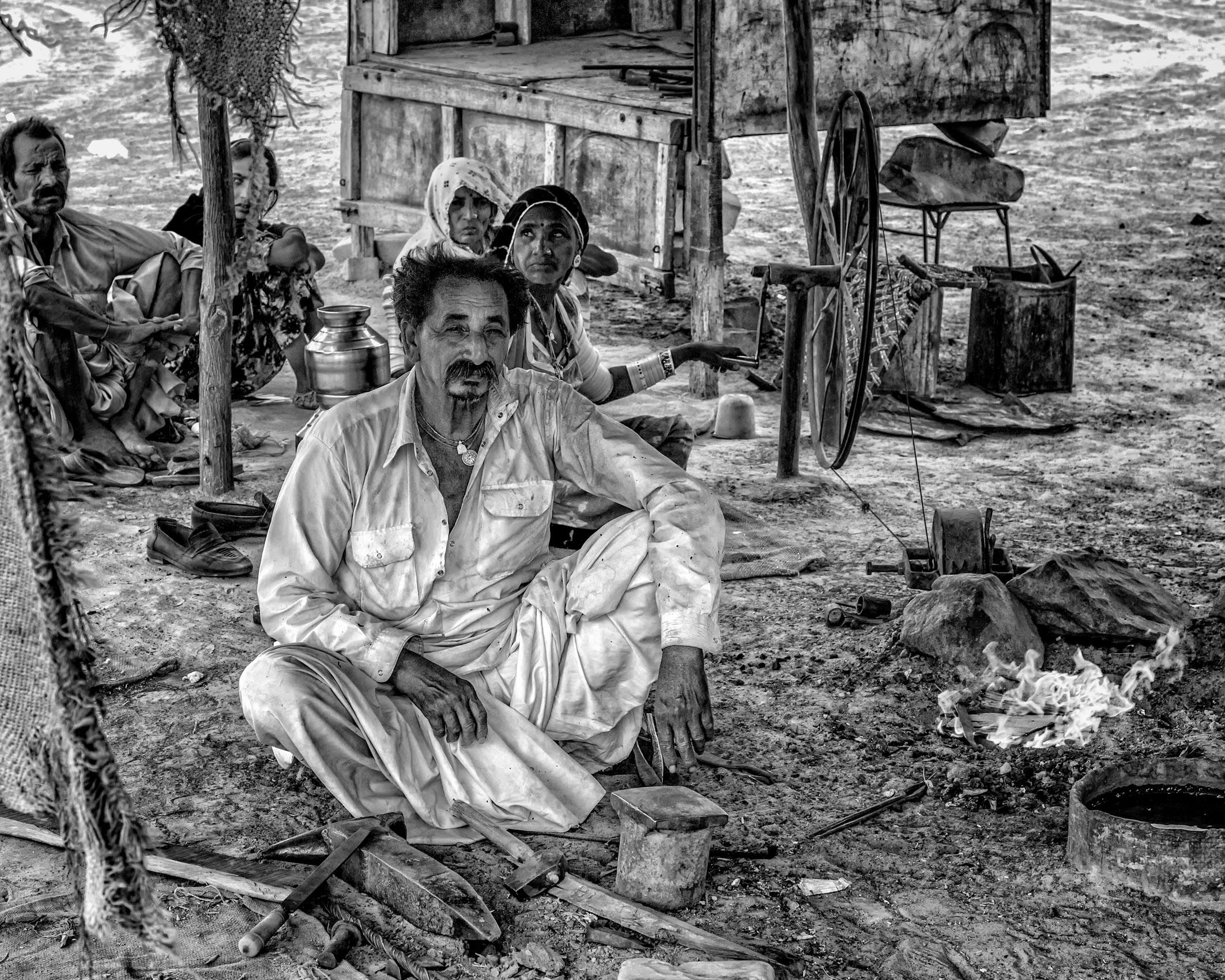 Smith at His Forge, with his Wife Fanning the Fire (Village in the Rann of Kutch, Gujarat) work.artisans-9.jpg