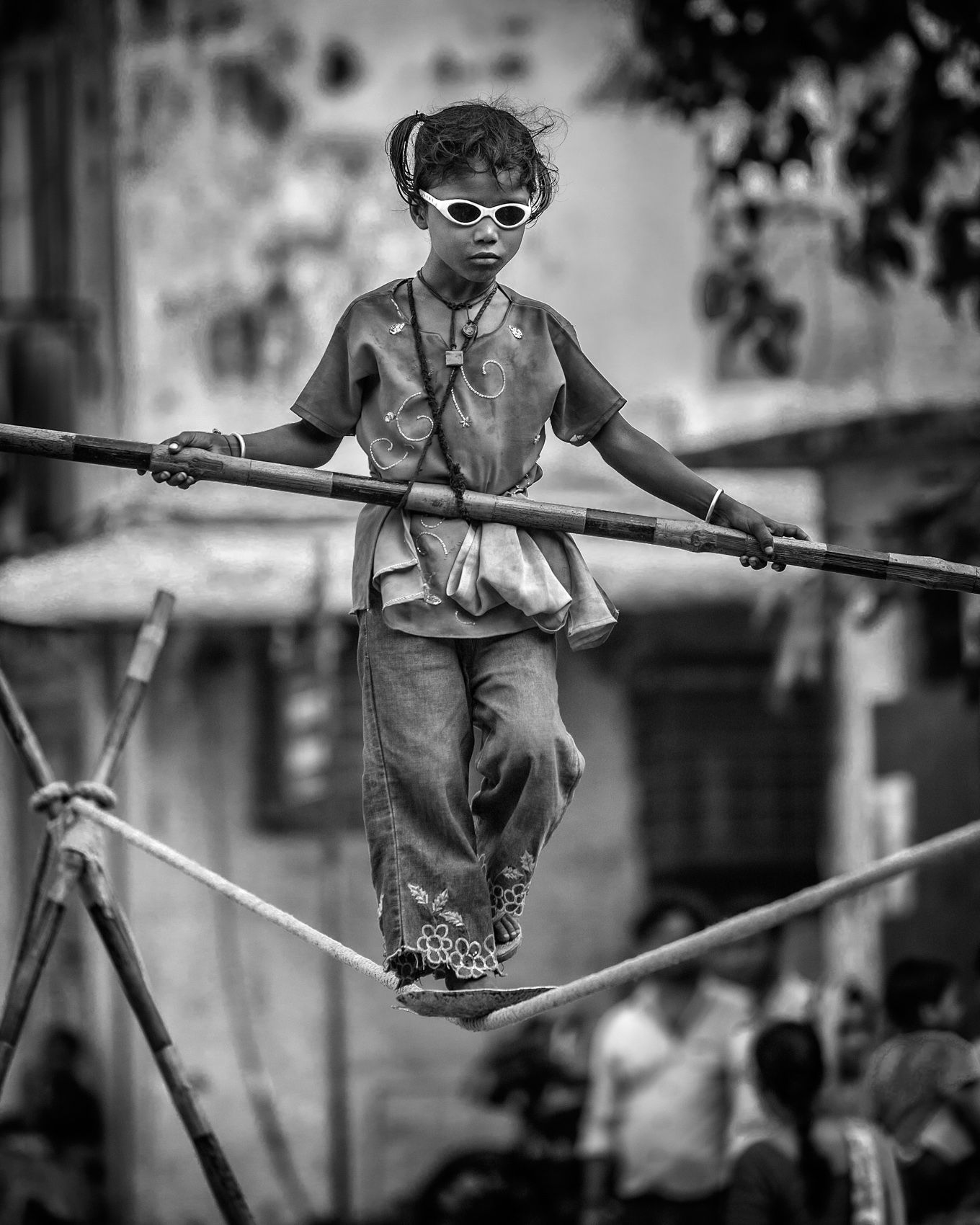 Child busker tightrope walking in the street (Mumbai) work.artisans-17.jpg