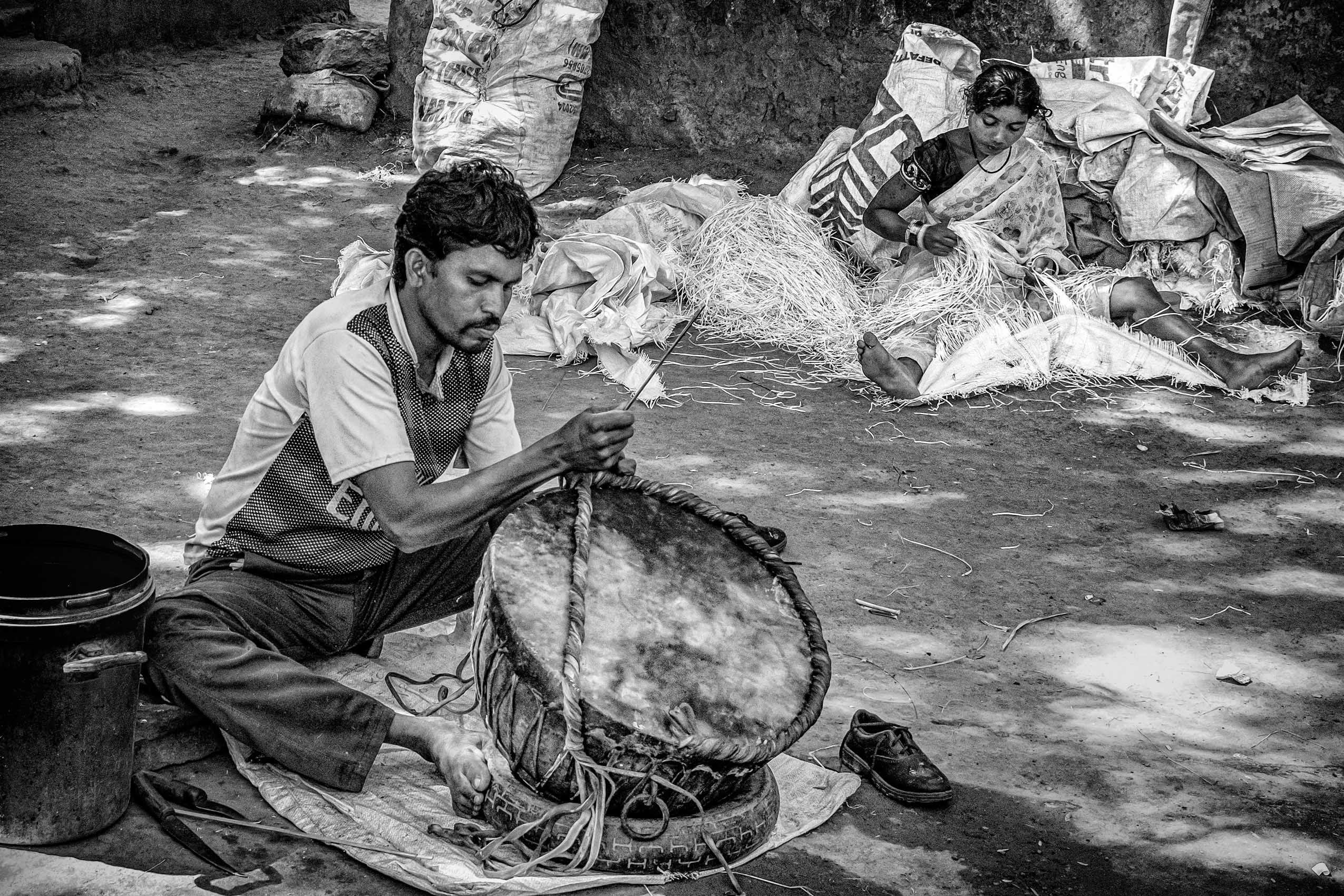 Cottage Industry in which the wife extracts plastic threads from sacks to reweave into ropes that the husband uses in repairing drums (Village in Chhattisgarh) work.laborers-28.jpg
