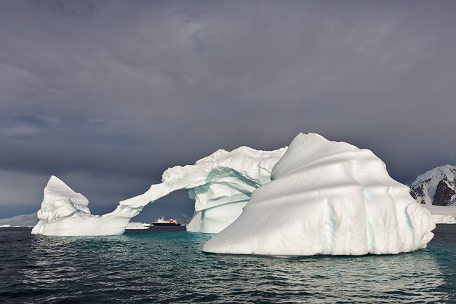 Ice-berg-with-arch-and-MV-Ortelius_S6A9198-Booth-Island-Antarctica.jpg