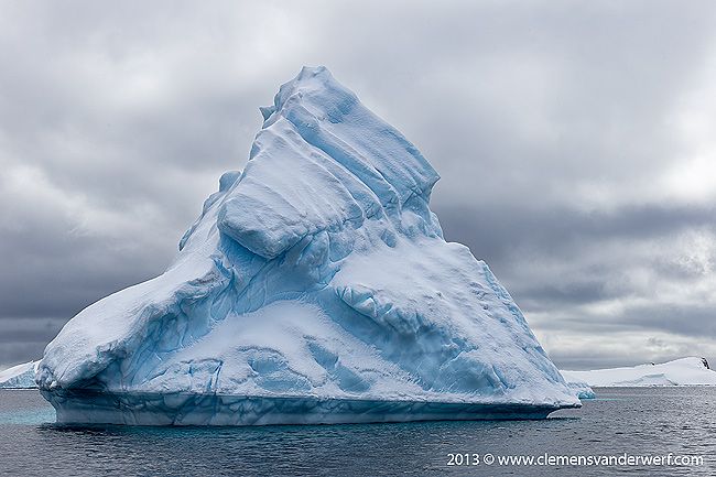 Ice-berg-floating-against-dramatic-sky_B8R6841-Lemaire-Channel-Gerlache-Strait-Antarctica.jpg