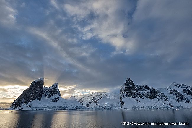 Morning-sun-hiding-behind-mountain-peaks_B8R6679-Lemaire-Channel-Gerlache-Strait-Antarctica.jpg