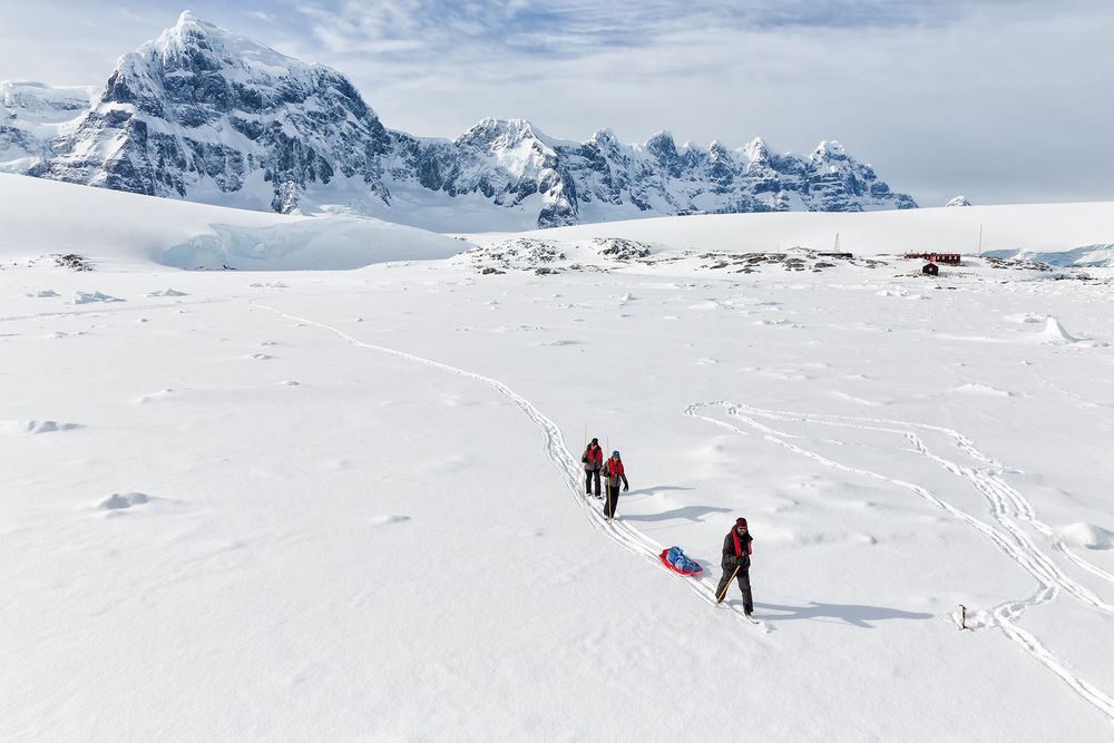 Trekkers-hiking-over-sea-ice_S6A0433-Port-Lockroy,-Antarctica.jpg