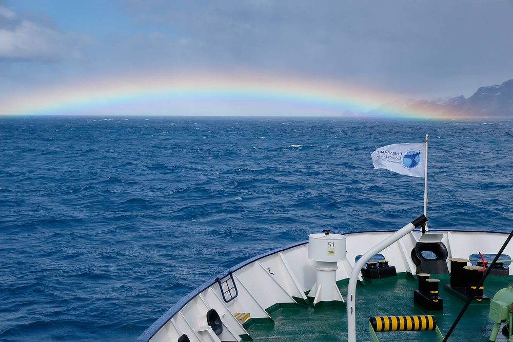 Rainbow-over-the-ships-bow_B8R4703-Stromness-Bay-entrance,-South-Georgia-Islands,-Southern-ocean.jpg