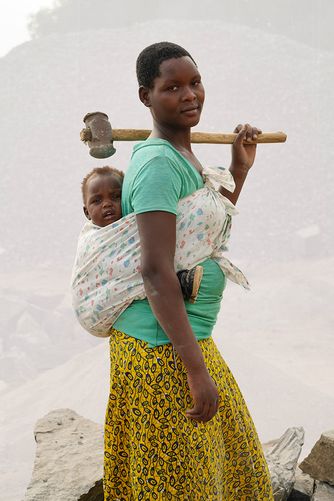 ADONG INNOCENT: AGE 19 AND HER SON MICHAEL AGE 14 MONTHS HAVE WORKED IN QUARRY FOR ONE YEAR. BREAKING STONES TO GRAVEL SIZE, FILLING 10 JERRYCANS OF GRAVEL PER DAY AT 1,000 UGX PER ($0.32 USD)