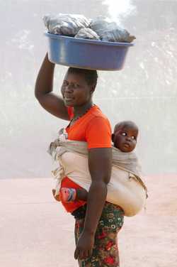 ALOYO JACKINE: AGE 26 & HER DAUGHTER BLESSINGS: AGE 2 SELLING CHARCOAL FOR 3 YEARS