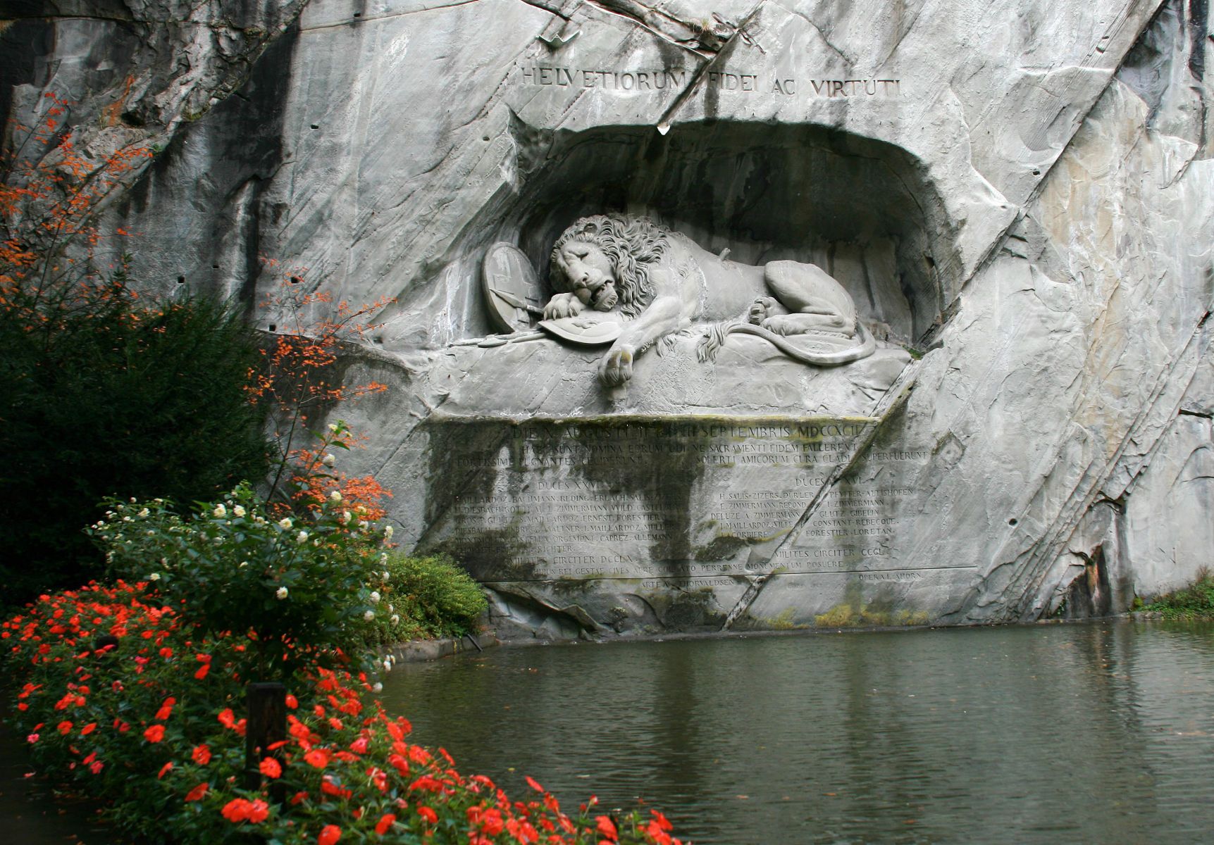 The Lion Monument carved out of a wall of sandstone rock above a pond in Lucerne, Switzerland. The Lion Monument