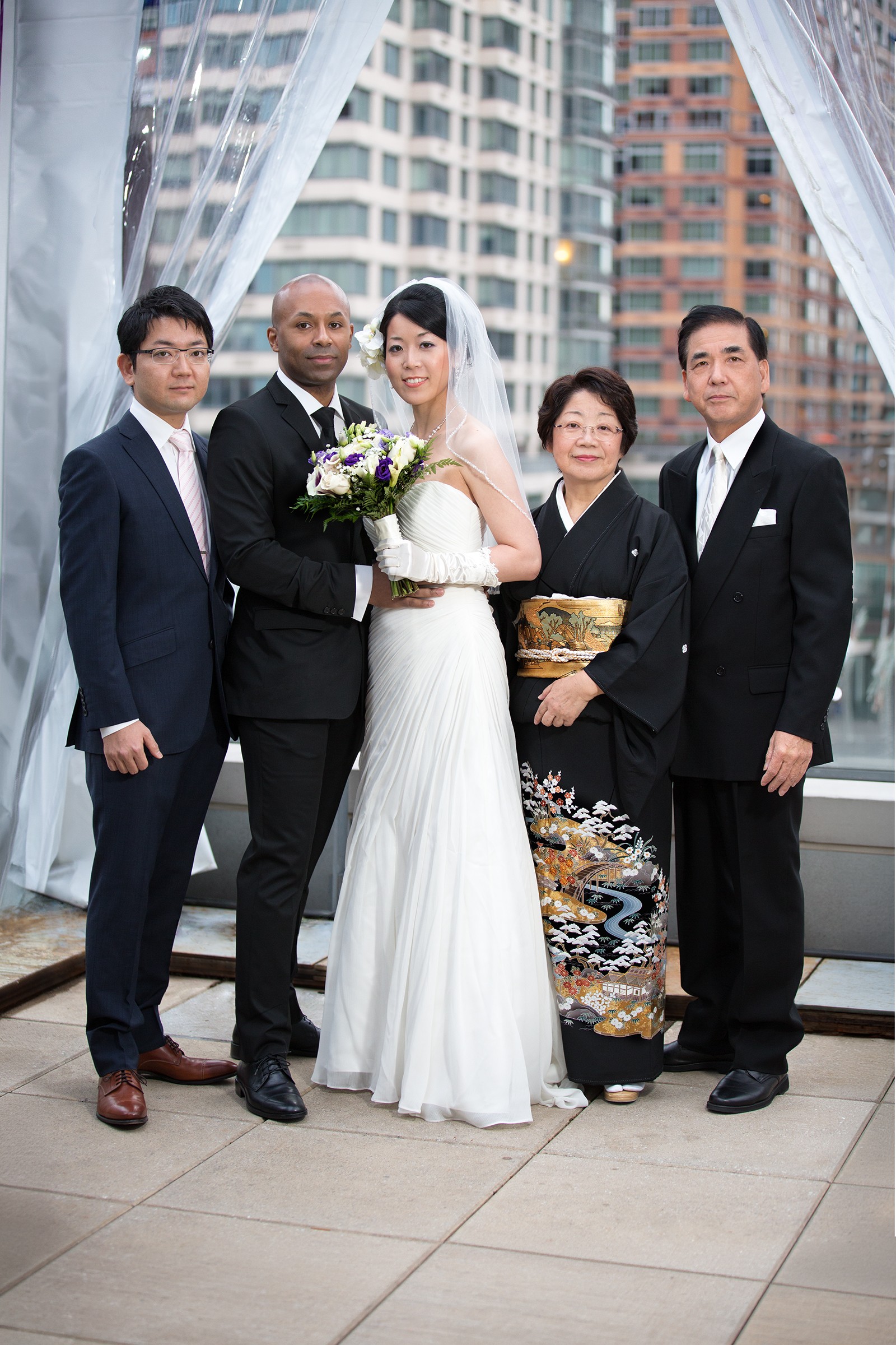 Groom with Japanese family on Kimpton Hotel Eventi rooftop