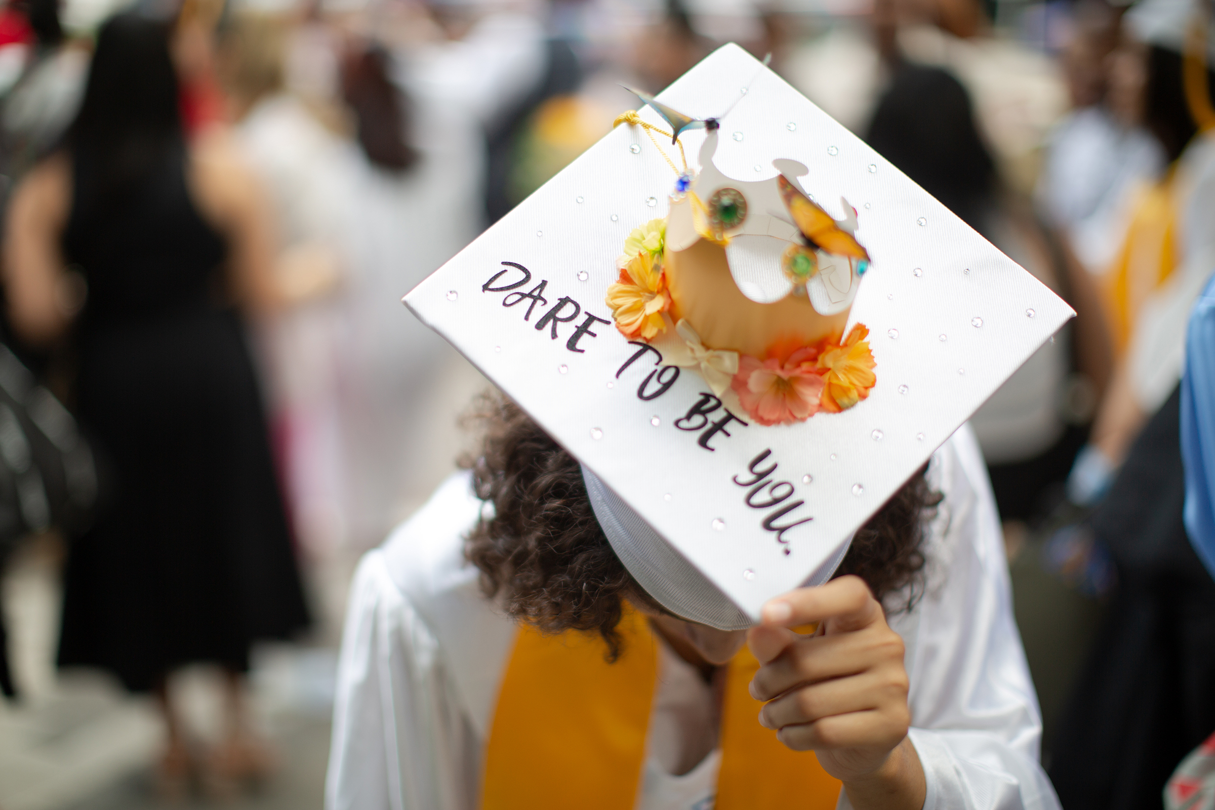 Decorated graduation cap reading “Dare to Be You”