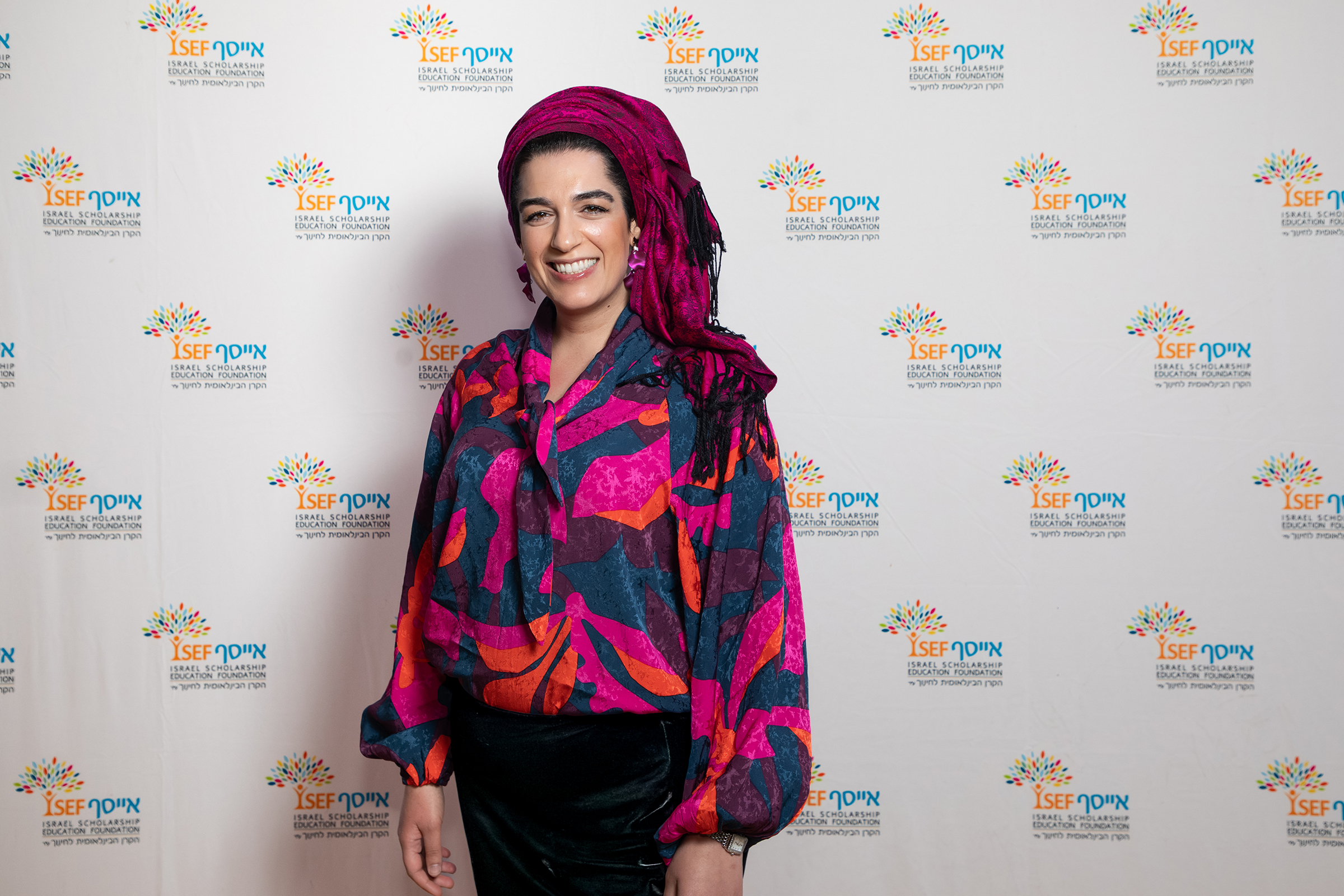 Woman in colorful outfit and turban at gala