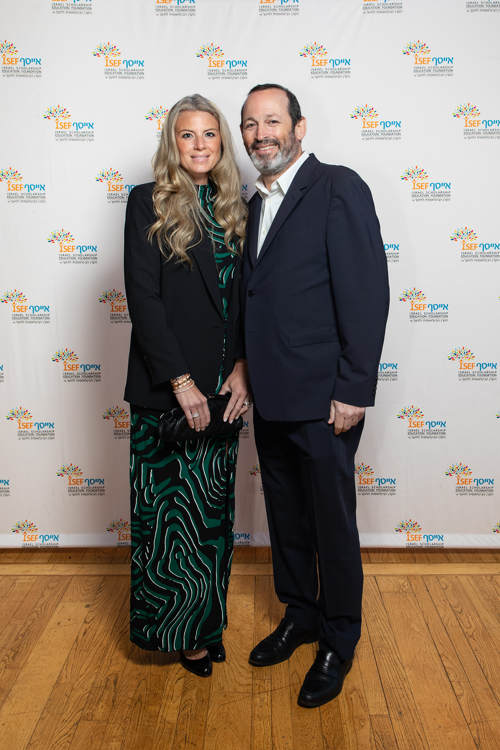 Elegant couple at nonprofit gala step and repeat