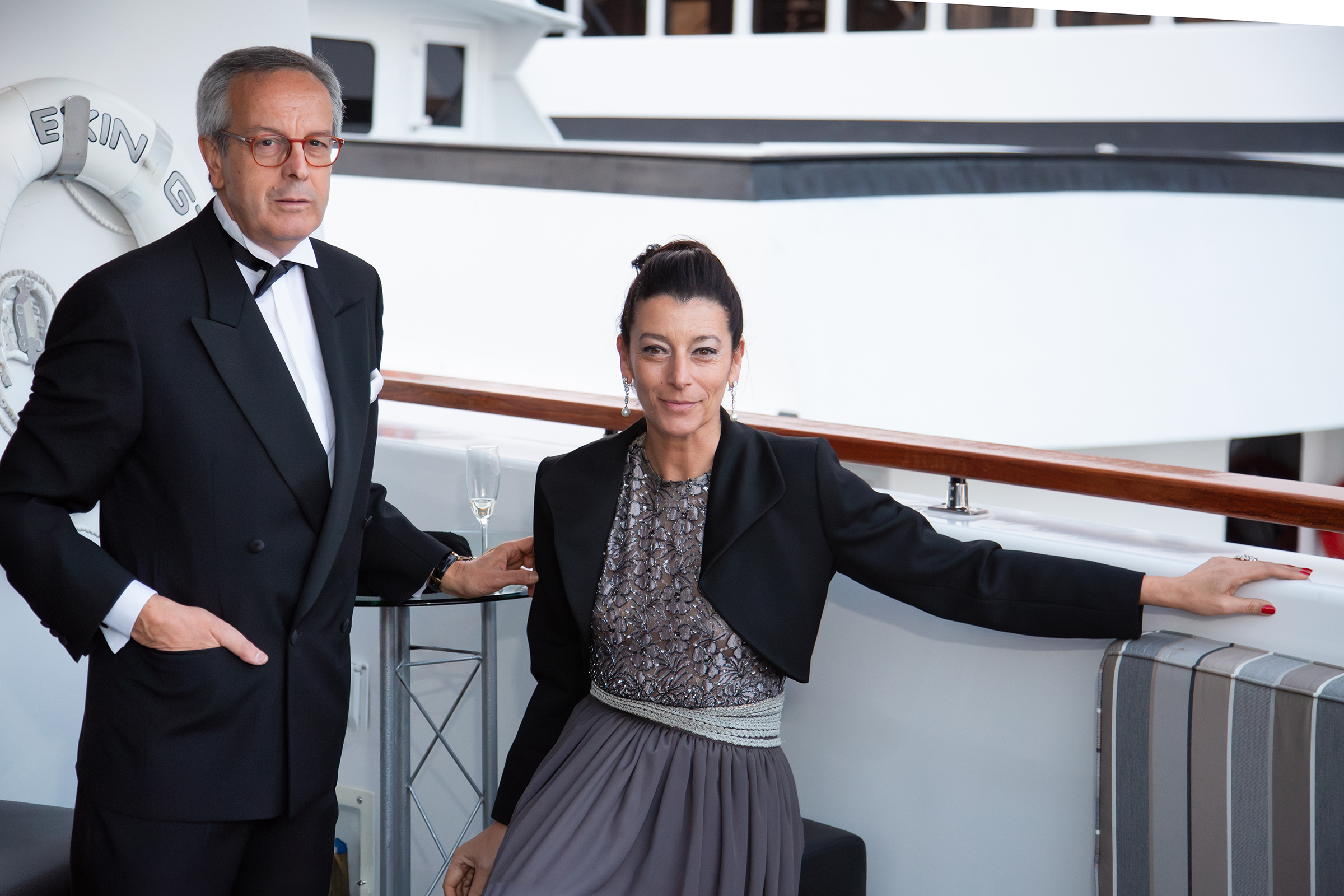 Elegant Italian couple in black evening wear aboard Hudson River cruise