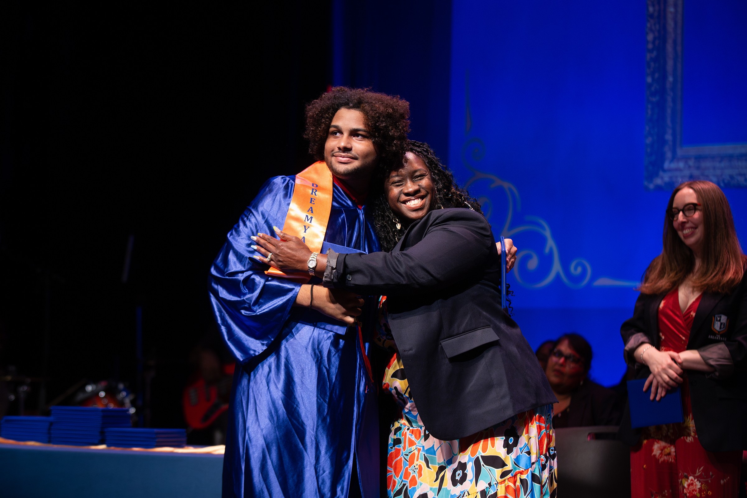 Nakia Perkinson hugging graduate Luis Peña Pichardo