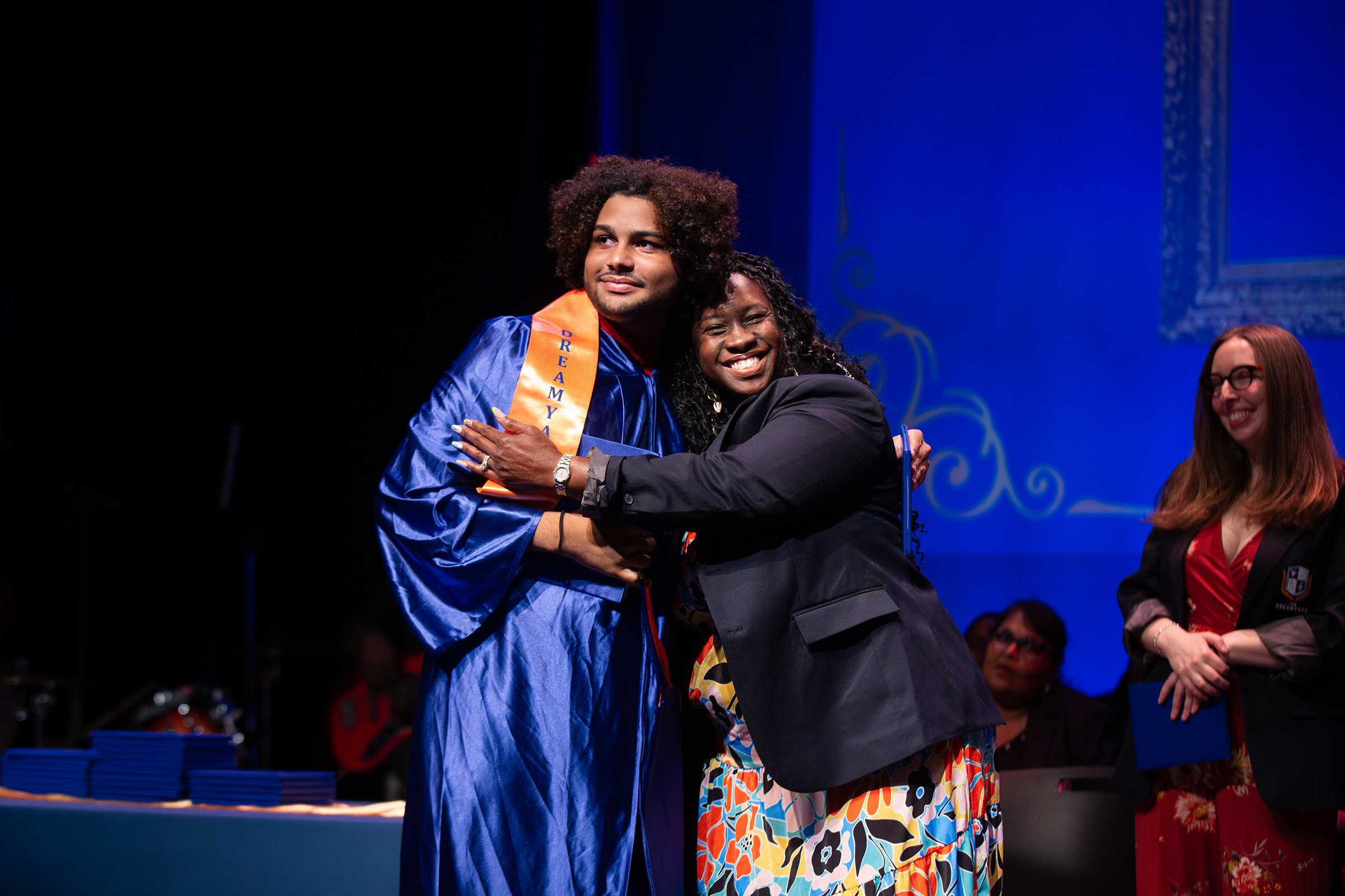Nakia Perkinson hugging graduate Luis Peña Pichardo
