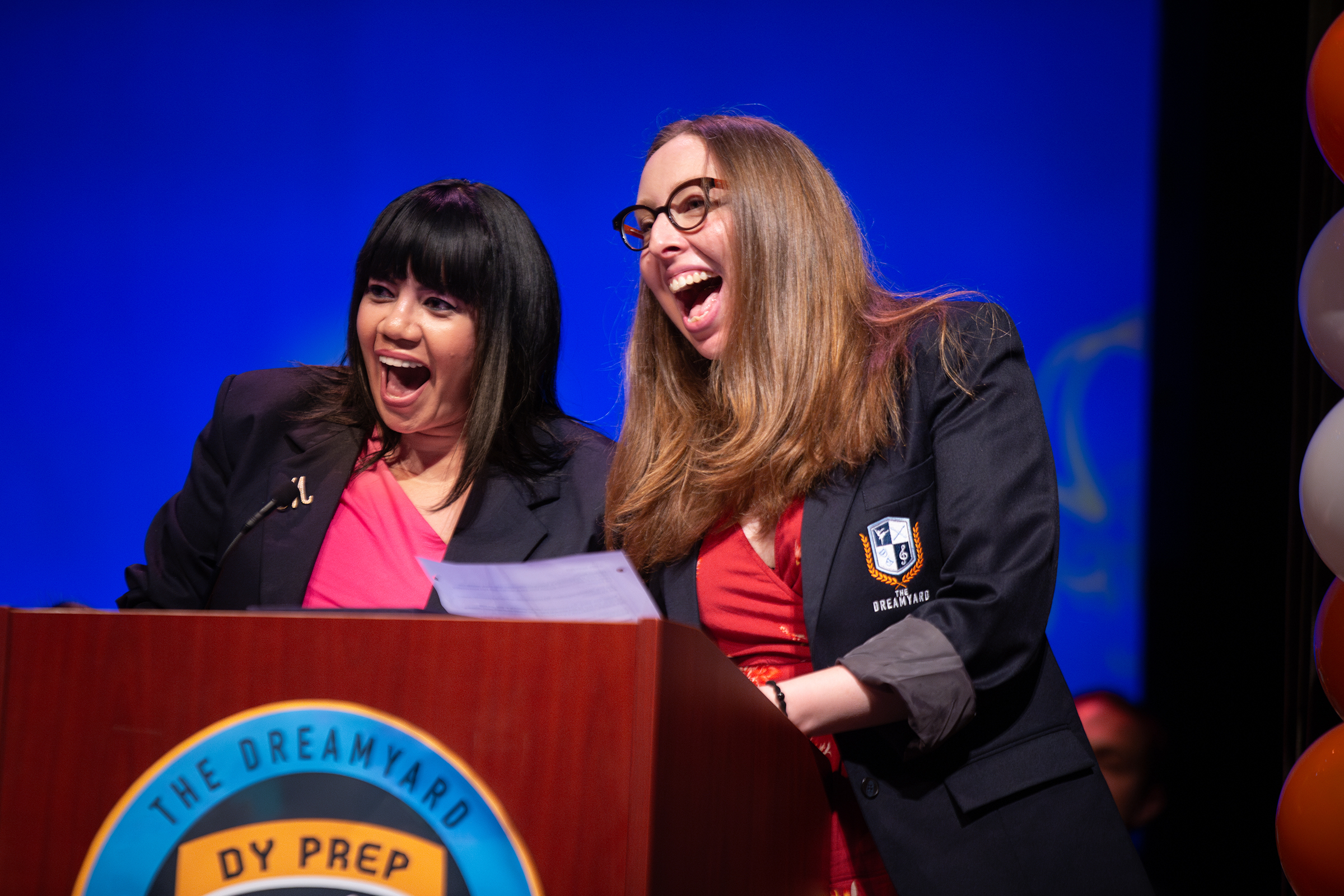 Teachers excitedly presenting award at DramYard graduation