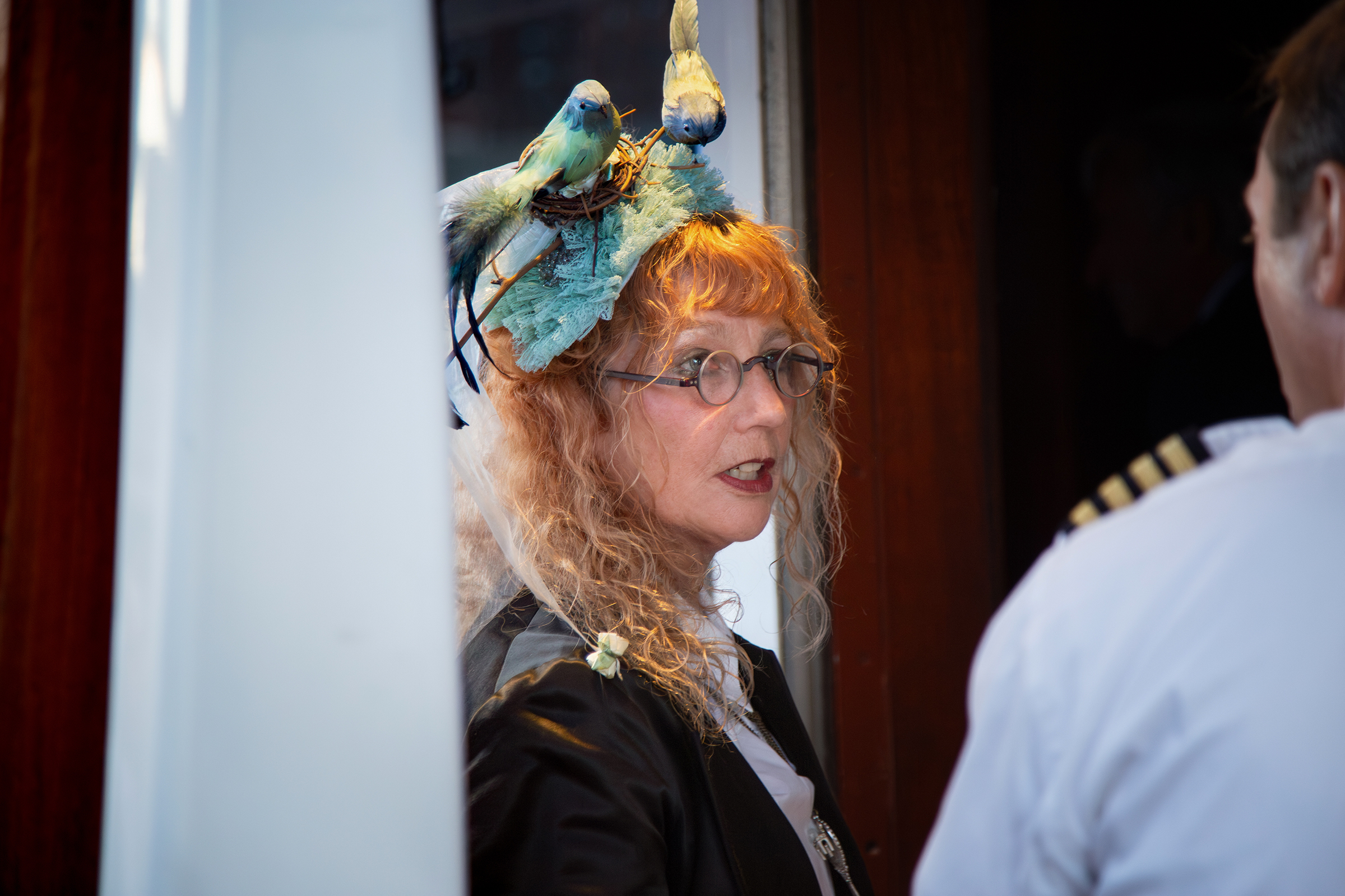Elegant woman in bird hat boarding Hudson River cruise ship
