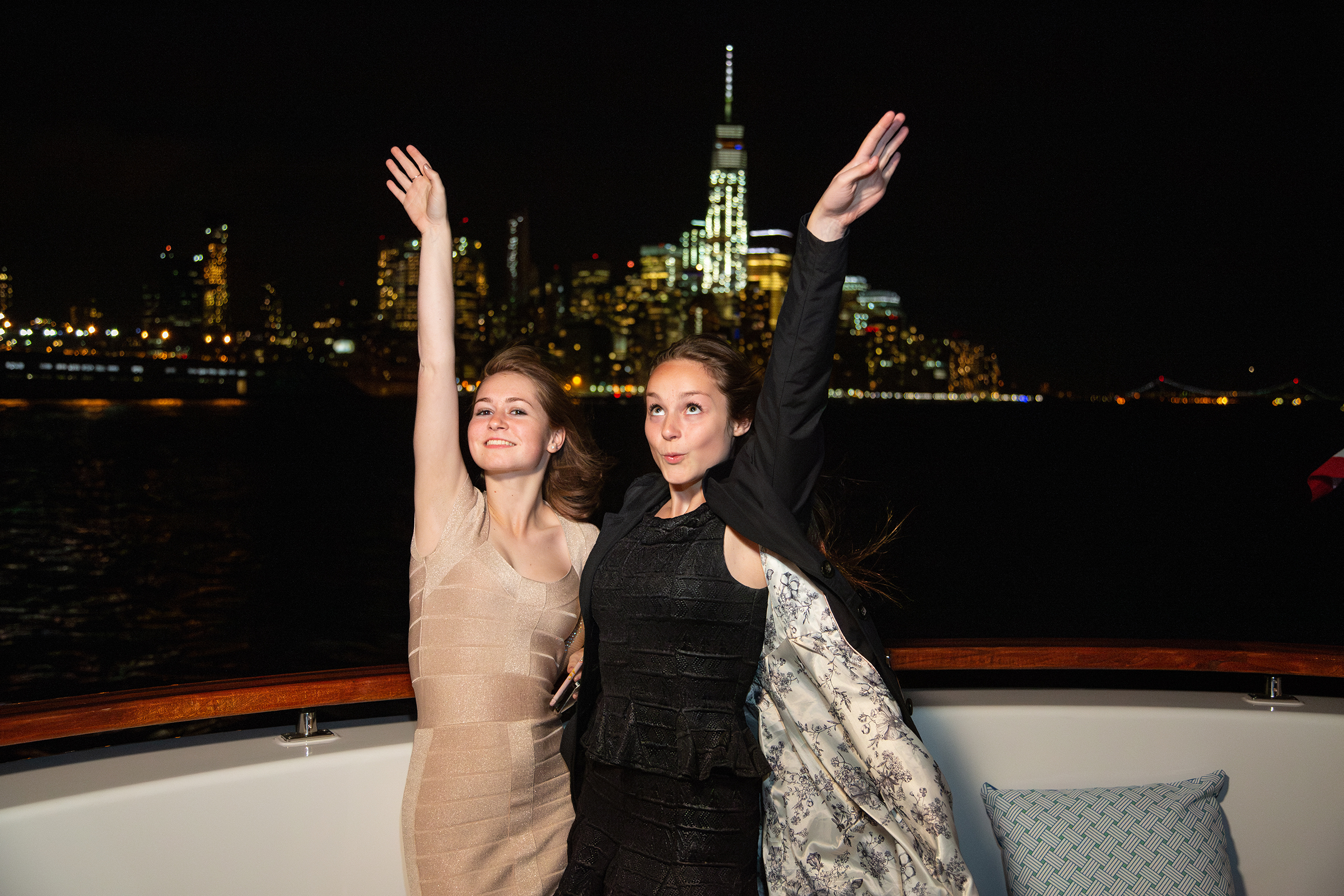 Teen sisters posing playfully with Empire State Building behind them