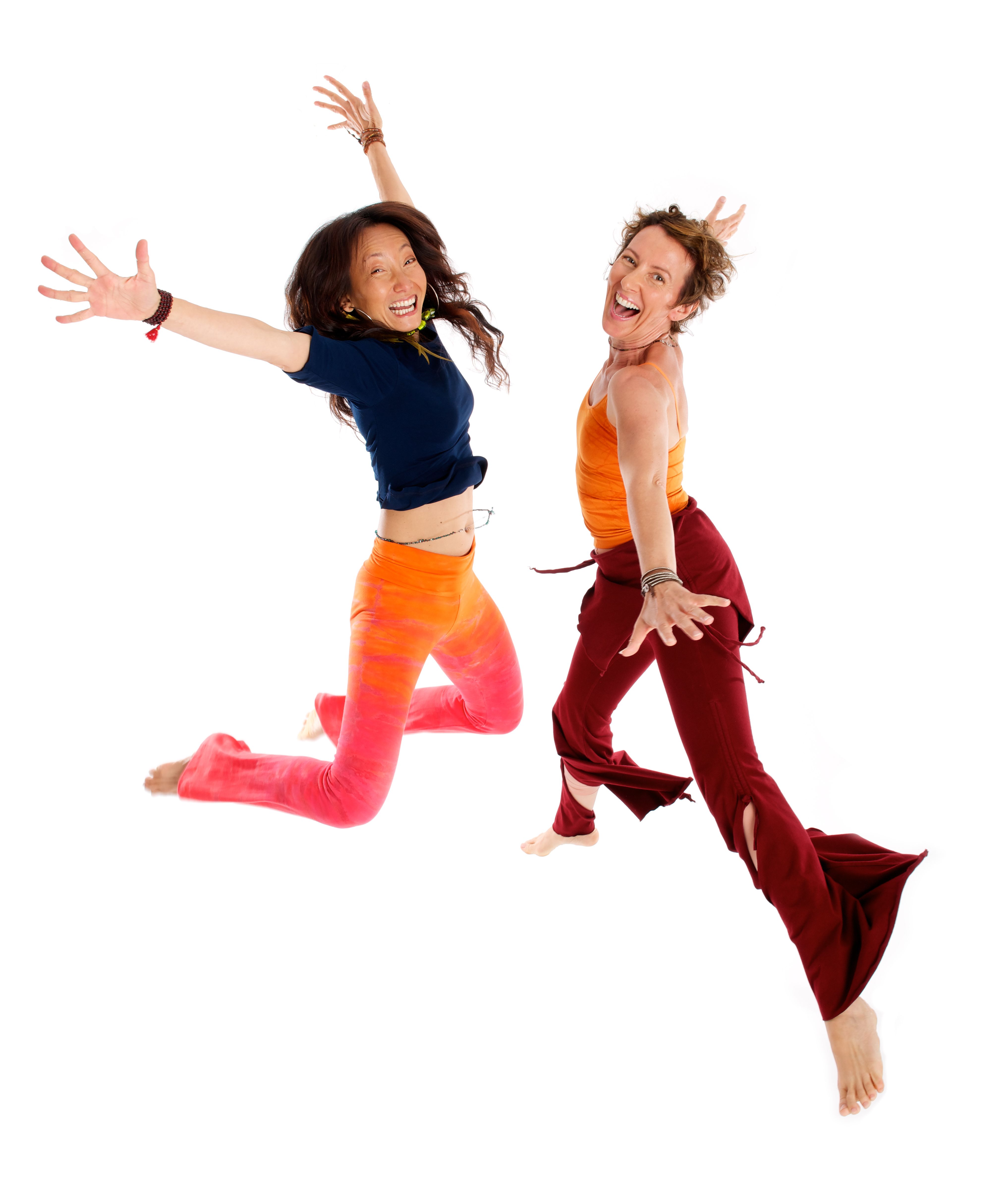 Two women jump in air on white studio portrait