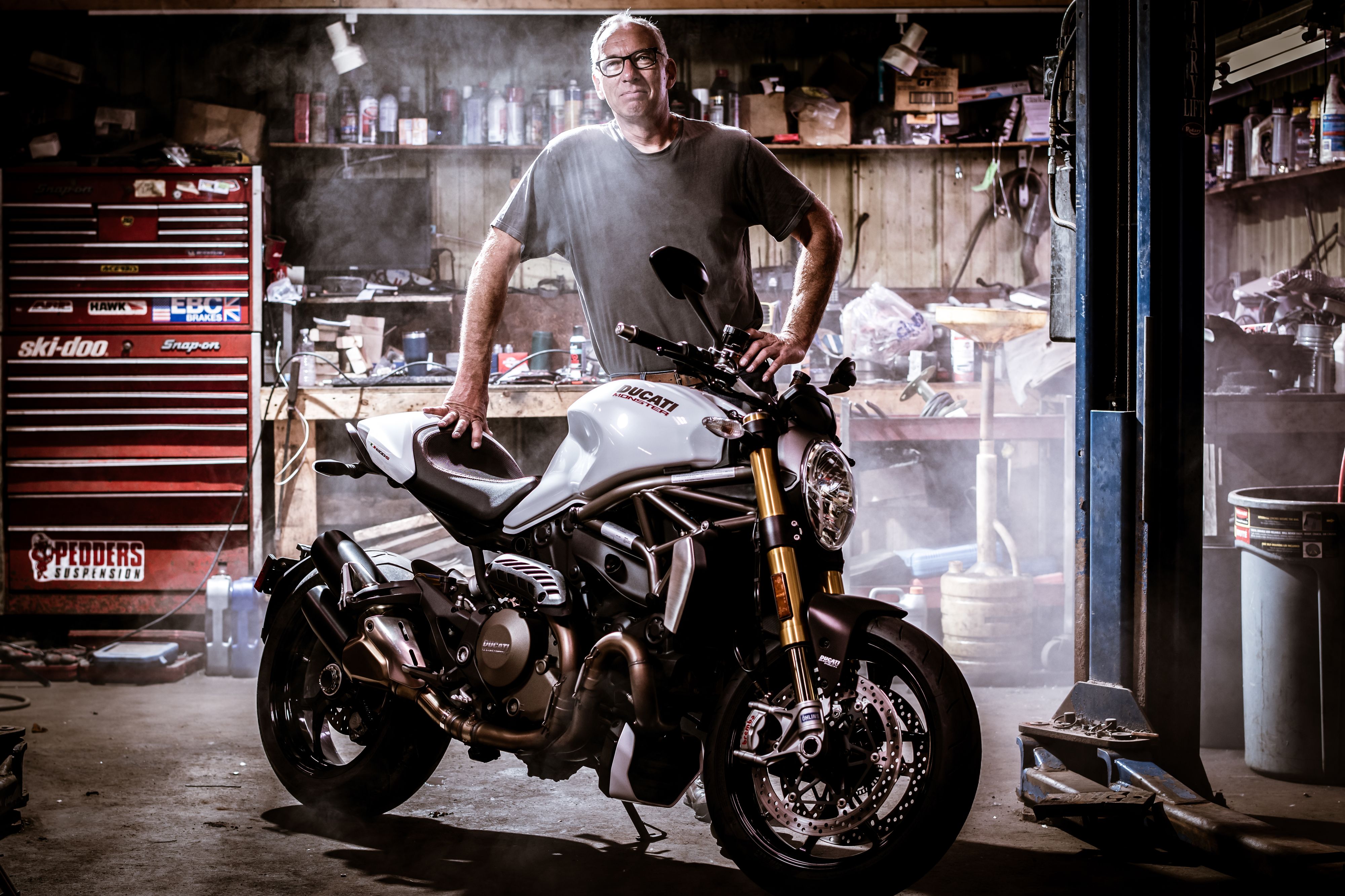 Man with white Ducati Monster motorcycle