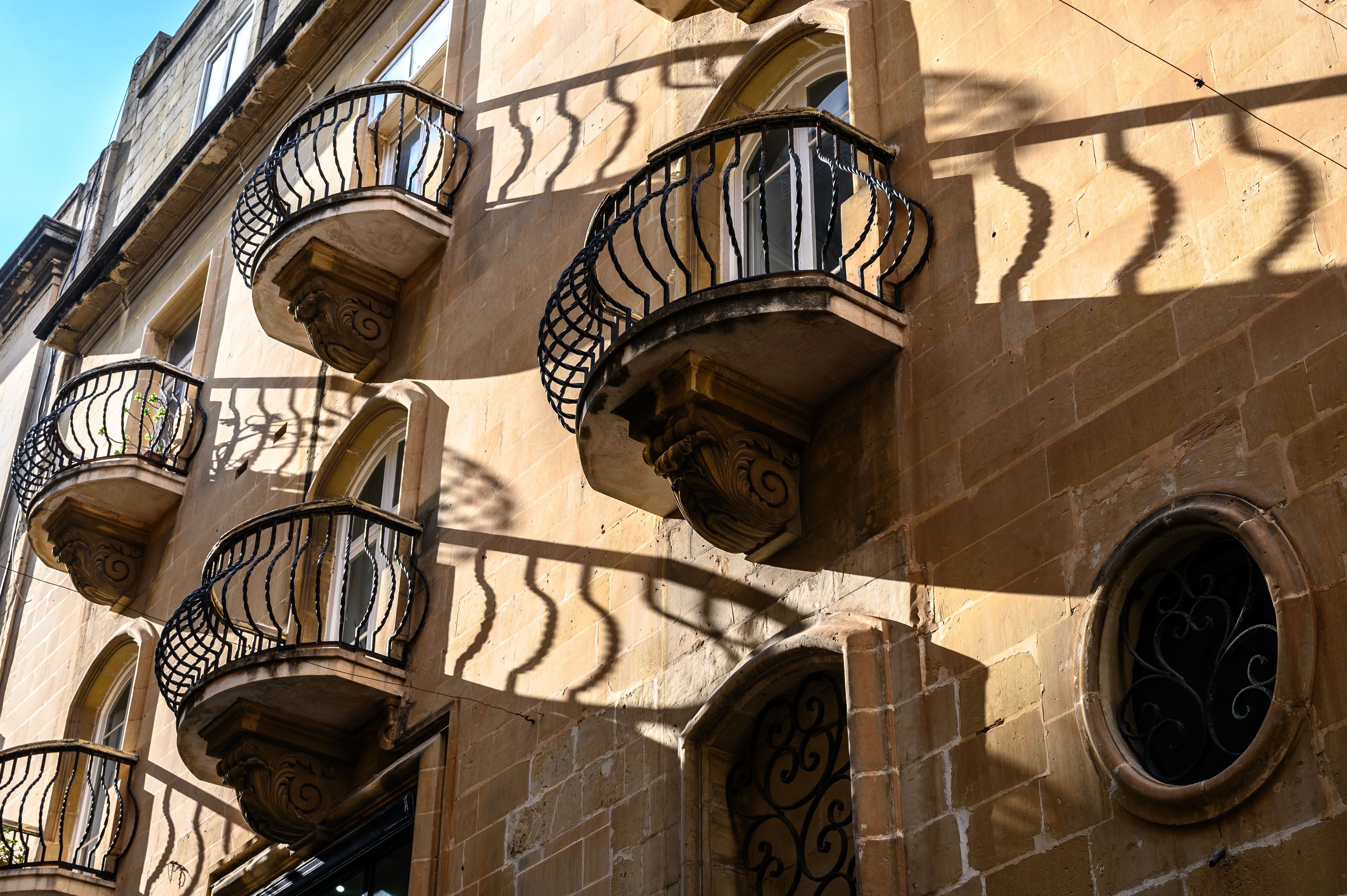Balconies in Malta with their ironwork shadows