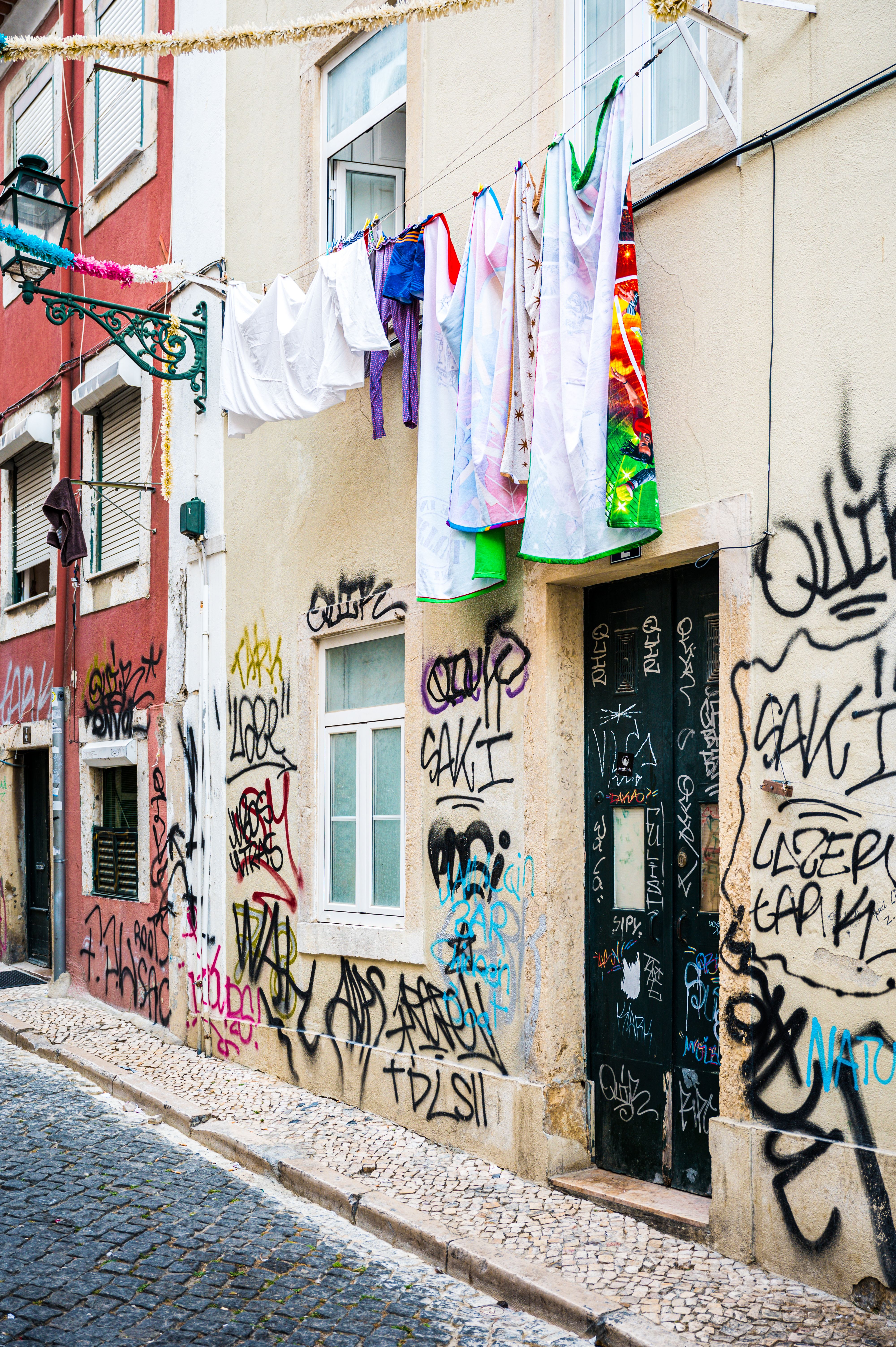 Graffiti covered home with hanging laundry in Lisbon, Portugal