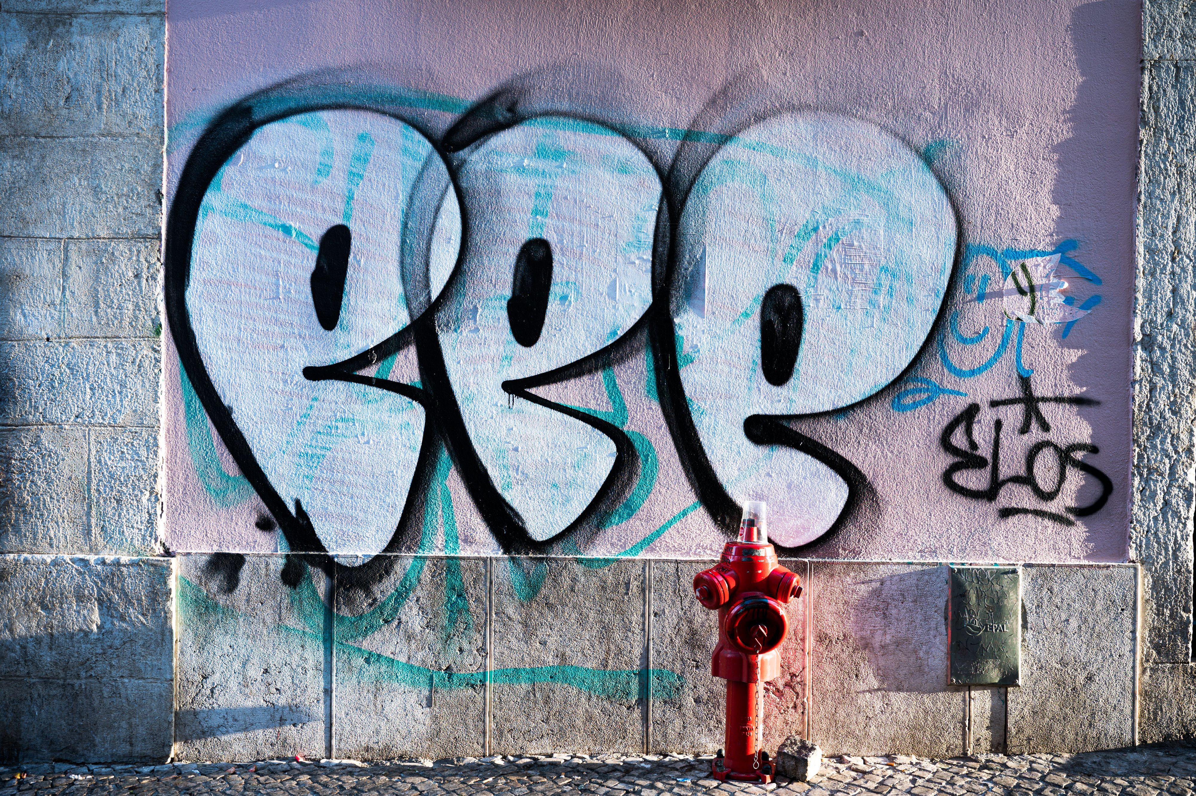 Wall in Lisbon Portugal with colorful graffiti and fire hydrant