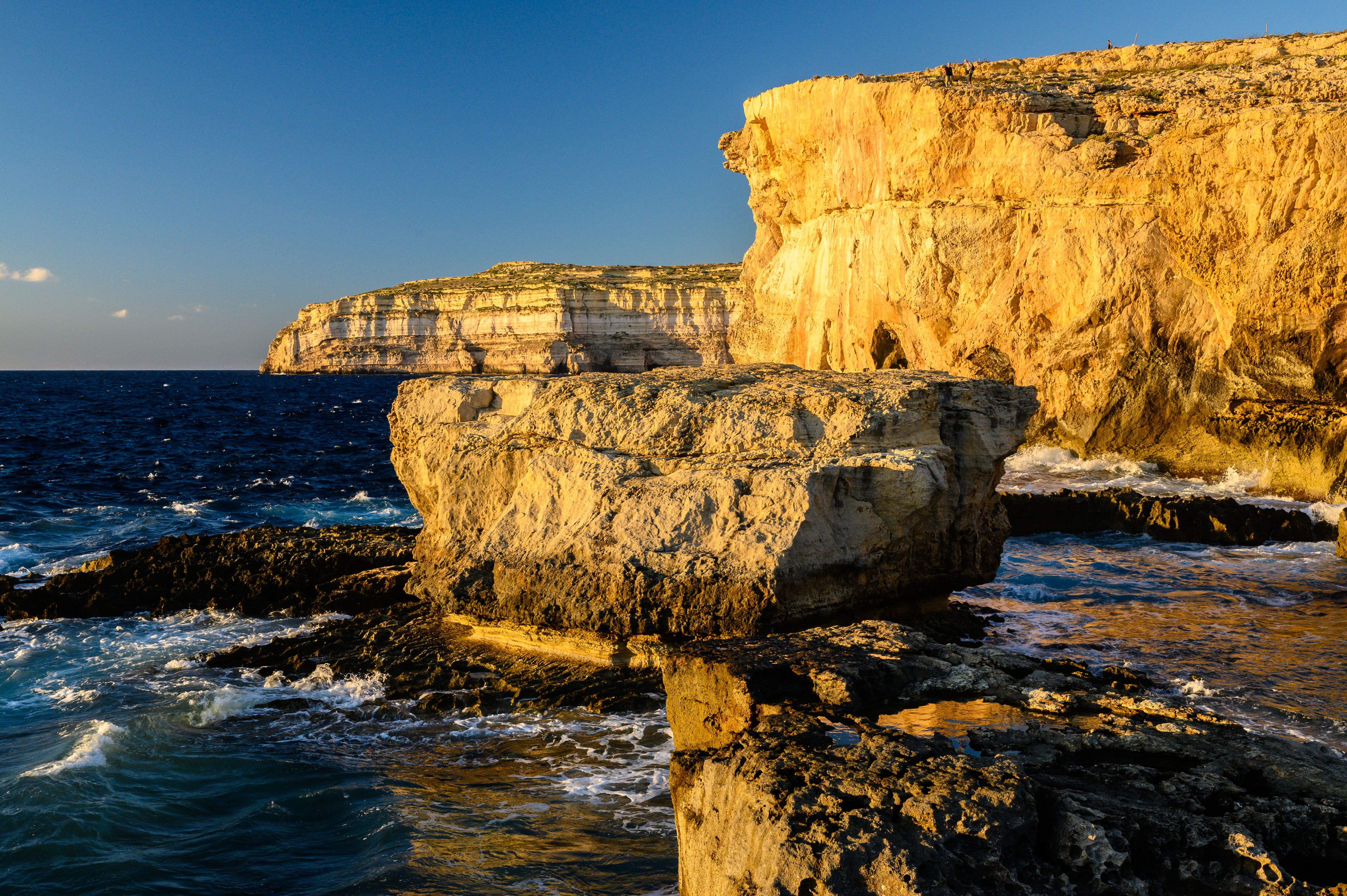 Rocky shoreline in Malta during golden hour
