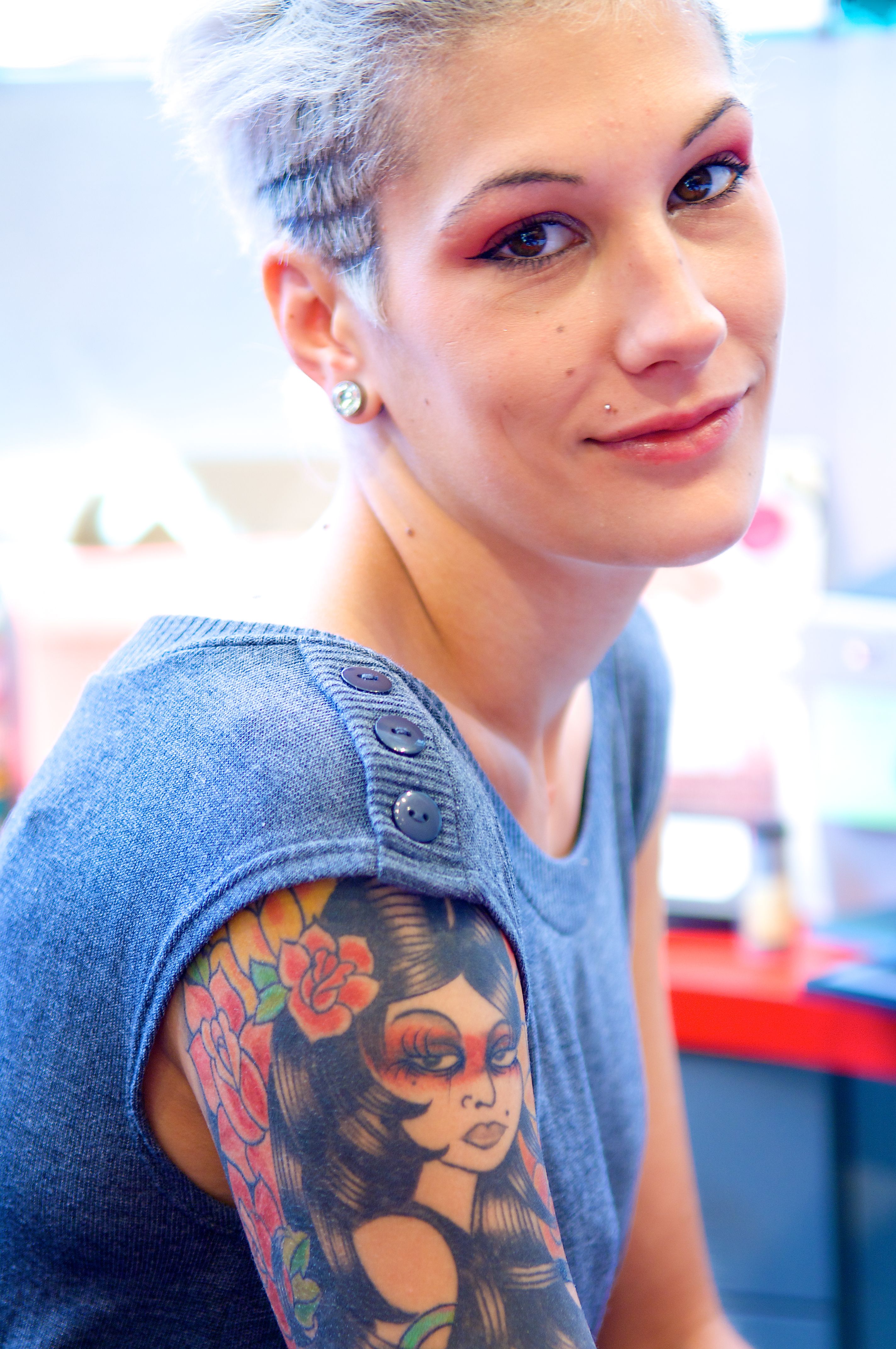 Portrait of young woman with colorful tattoos
