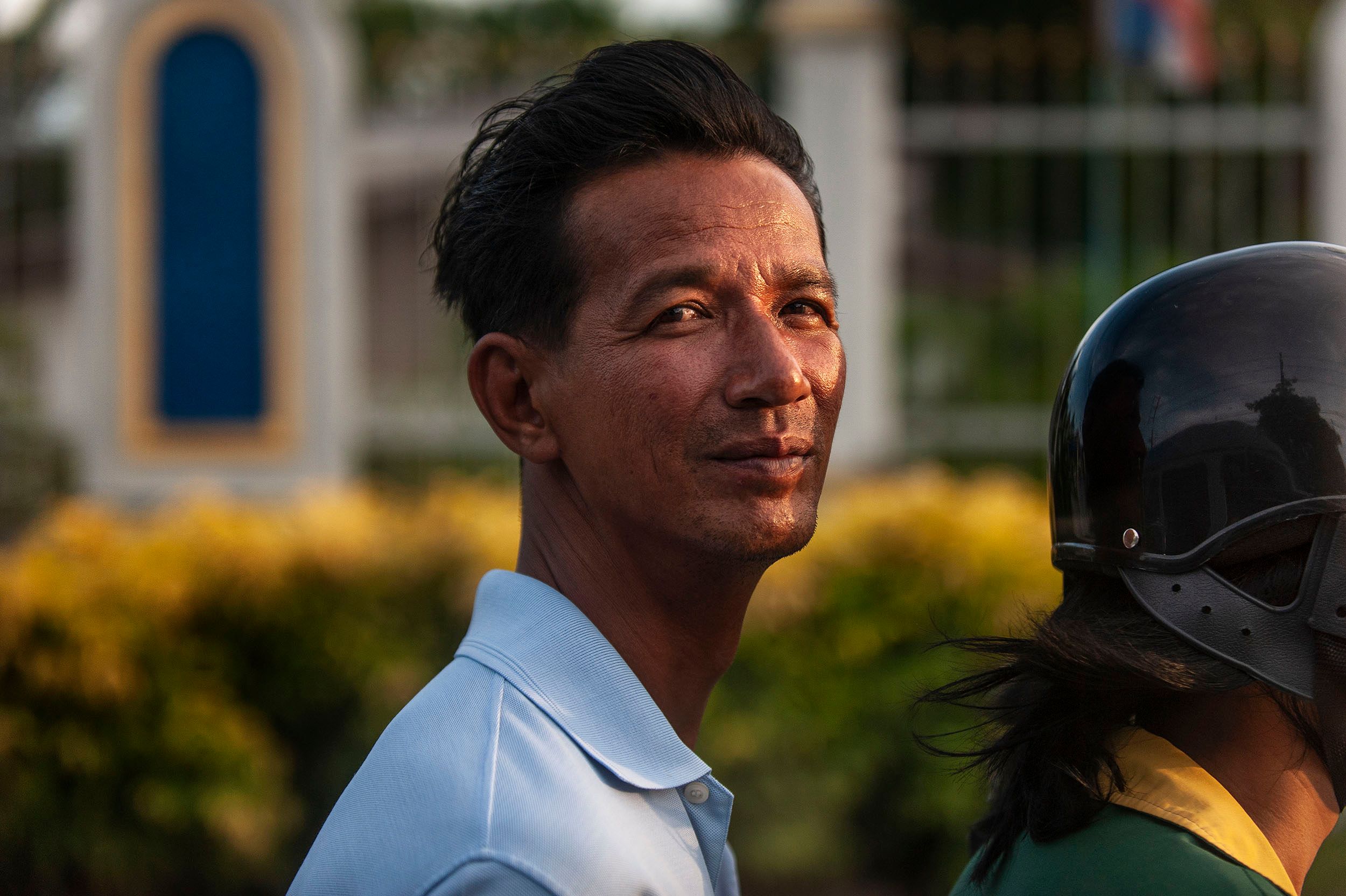 A momentary connection which lasts forever. Portraitof a man riding in traffic on the back of a motorcycle . Phuket, Thailand Man on Motorcycle