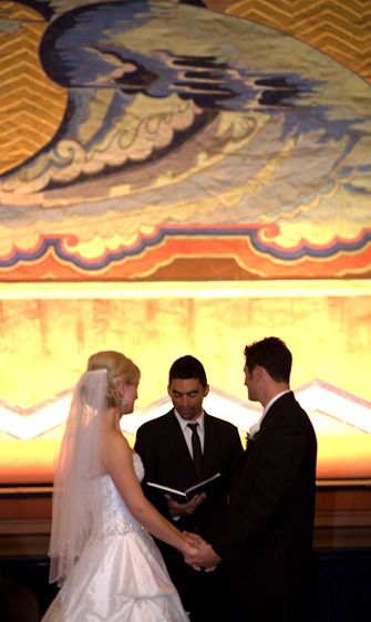 Tight shot of the officiant and the bride and groom.